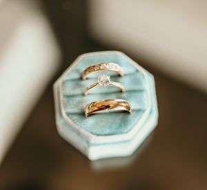 Three wedding rings displayed on a light blue velvet ring box.