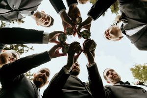 A series of black and white artistic photos showing low angle views of people looking down at the camera.