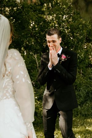 Candid sequence showing touching first look reactions during an outdoor wedding ceremony.