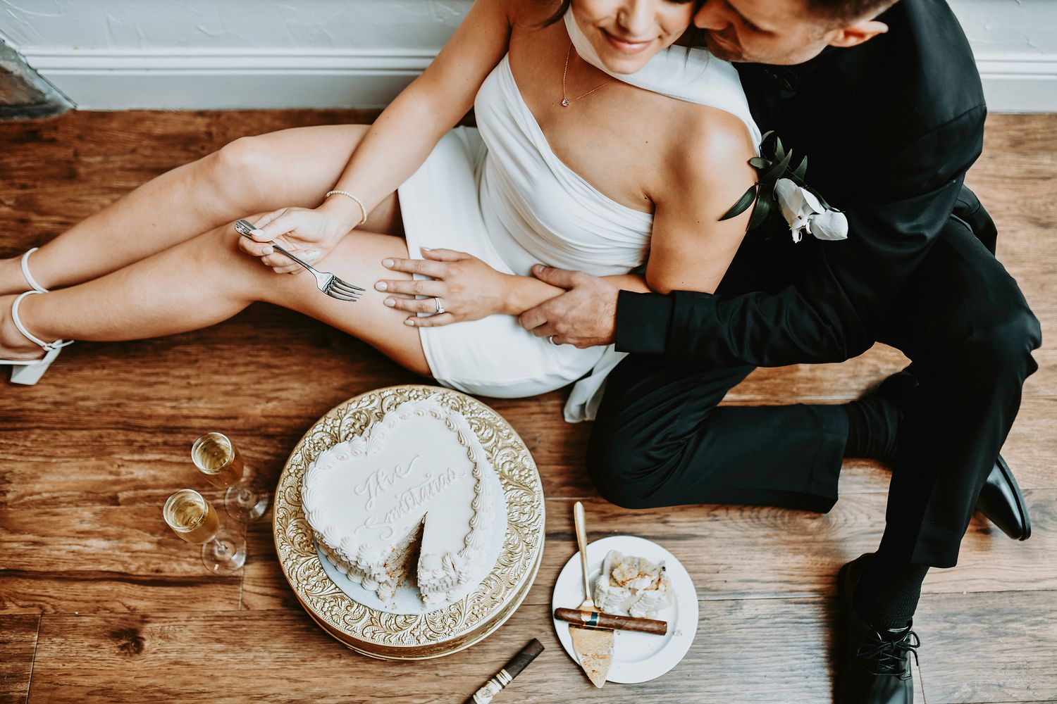 bride and groom enjoy post cocktail party wedding cake and champagne