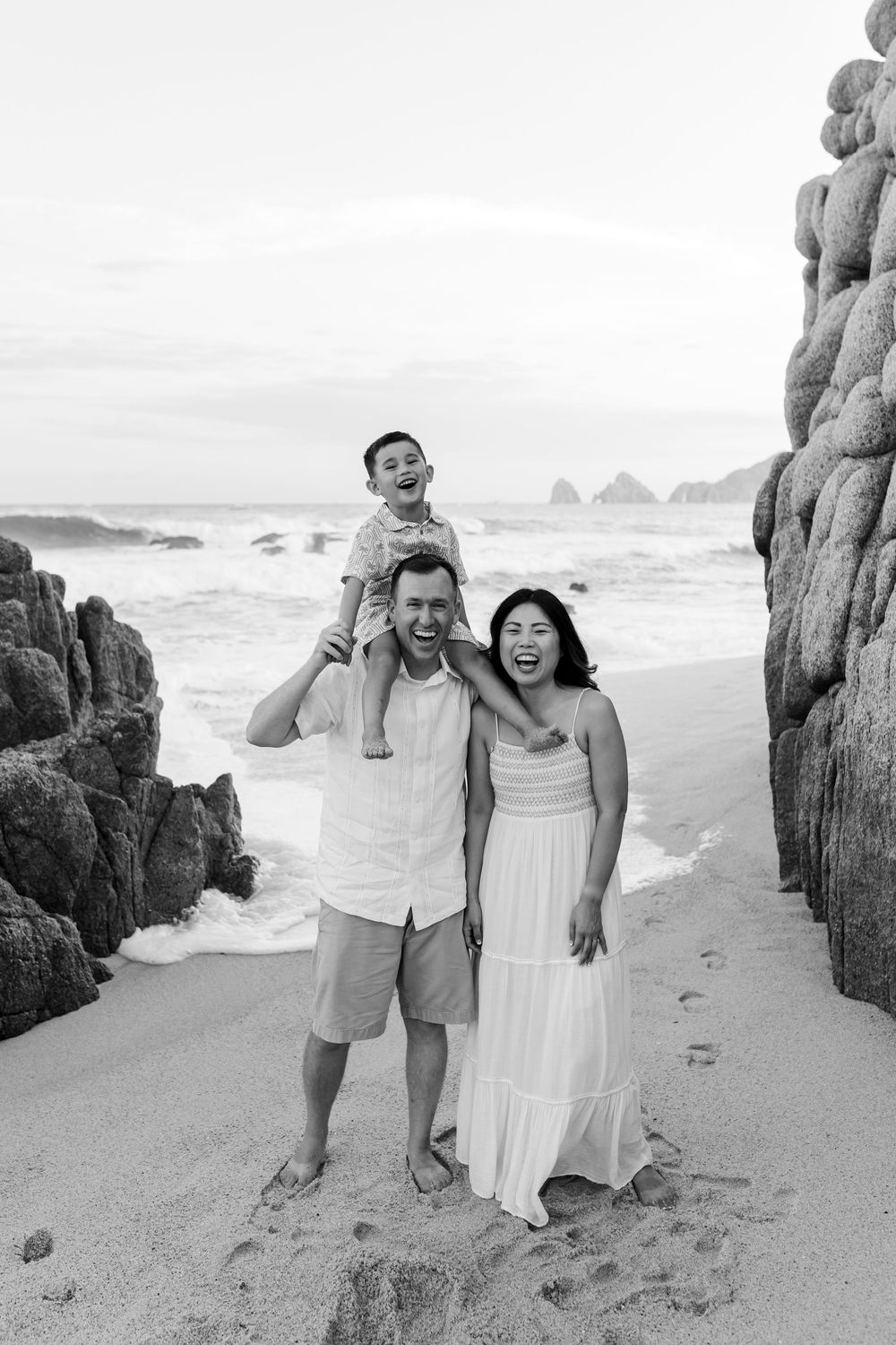Family hugging with ocean view in Cabo San Lucas