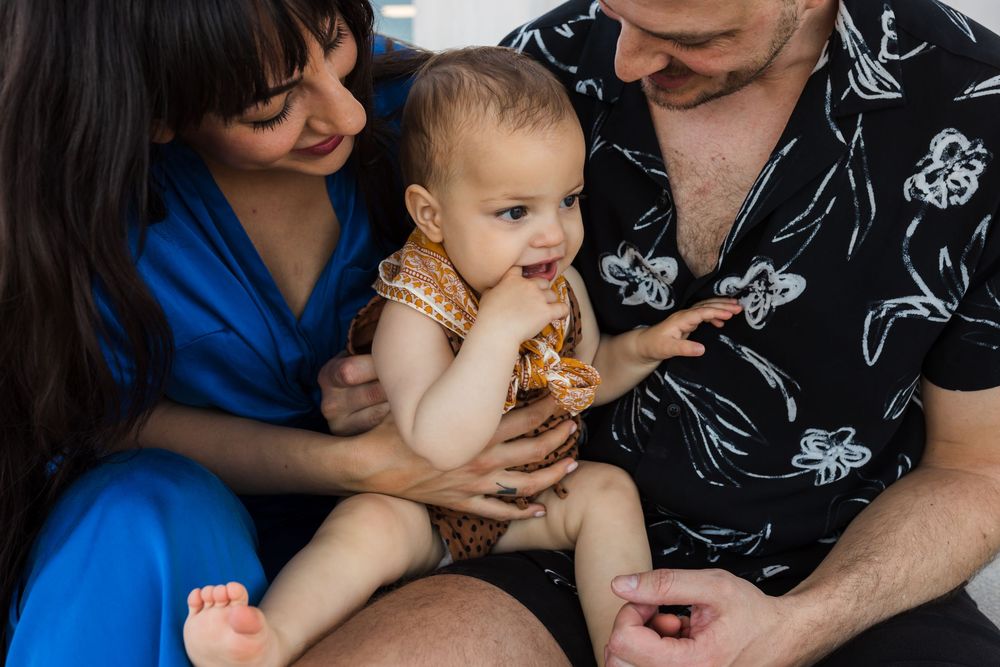 Parents kissing child during candid moment
