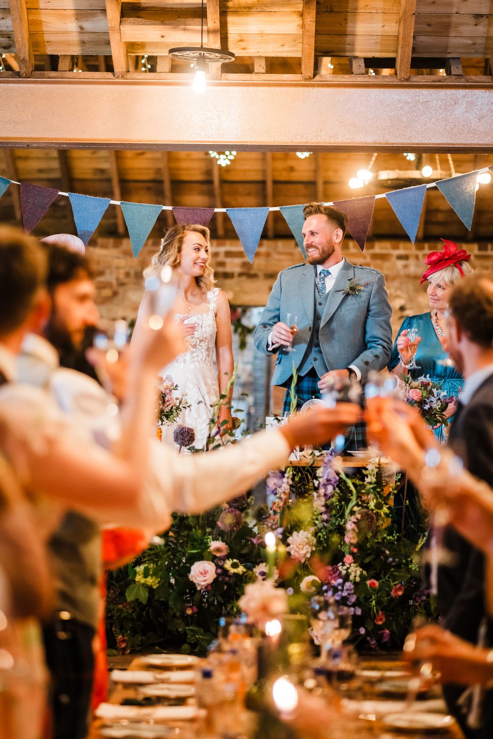 Bride and groom smiling at each other during wedding speeches and toast at the Rhynd near St Andrews, Fife