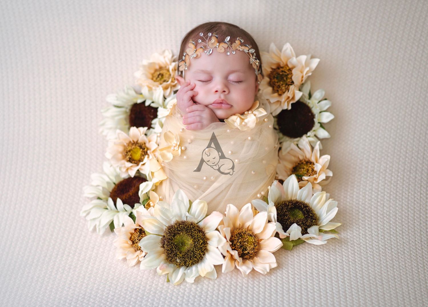 Peaceful newborn photography setup with white and yellow sunflowers on cream background.