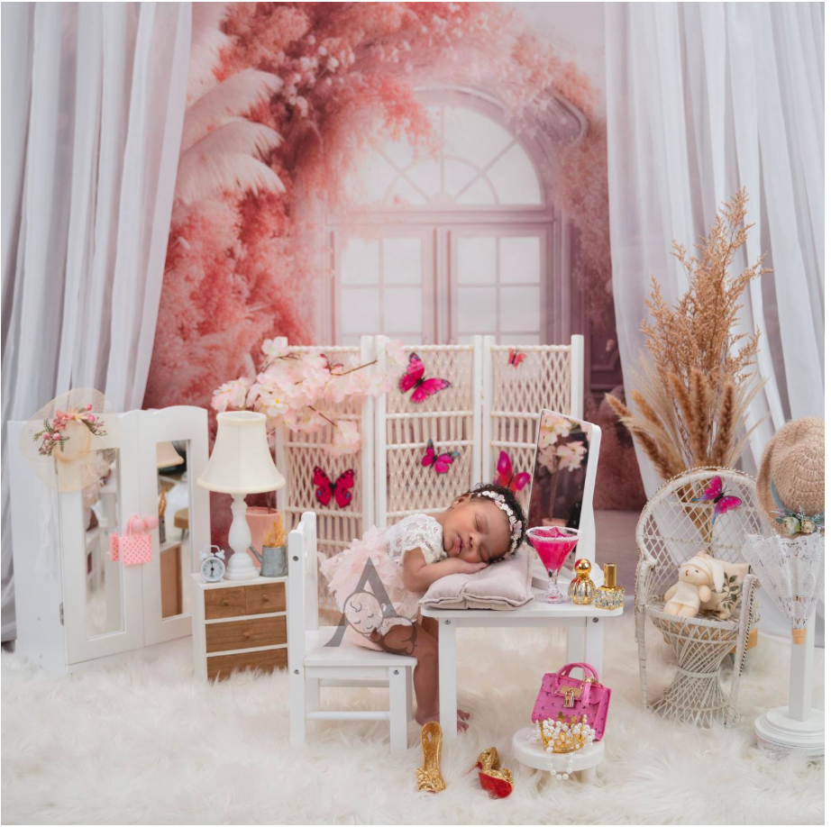 Dreamy nursery setup with white furniture, pink accents, and soft lighting.