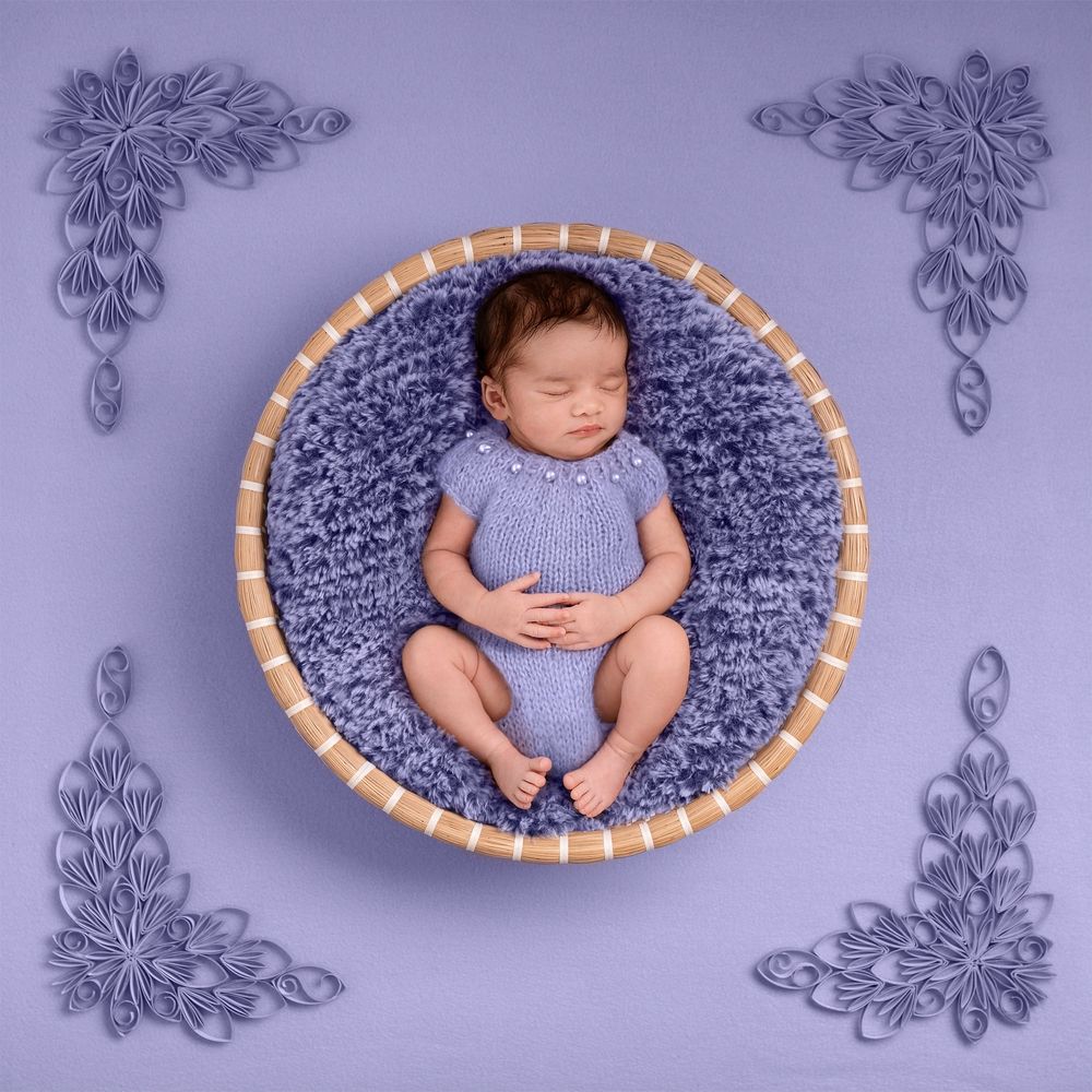 newborn baby photographer ashford kent  baby in basked in mauve tones natural pose