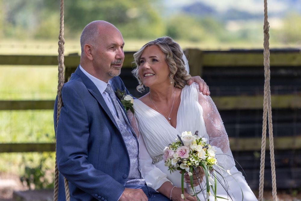 Bride and Groom on swing at Eastington Park