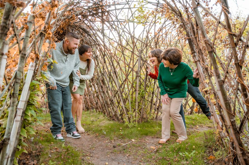 People playing and having fun among bare branches during autumn.