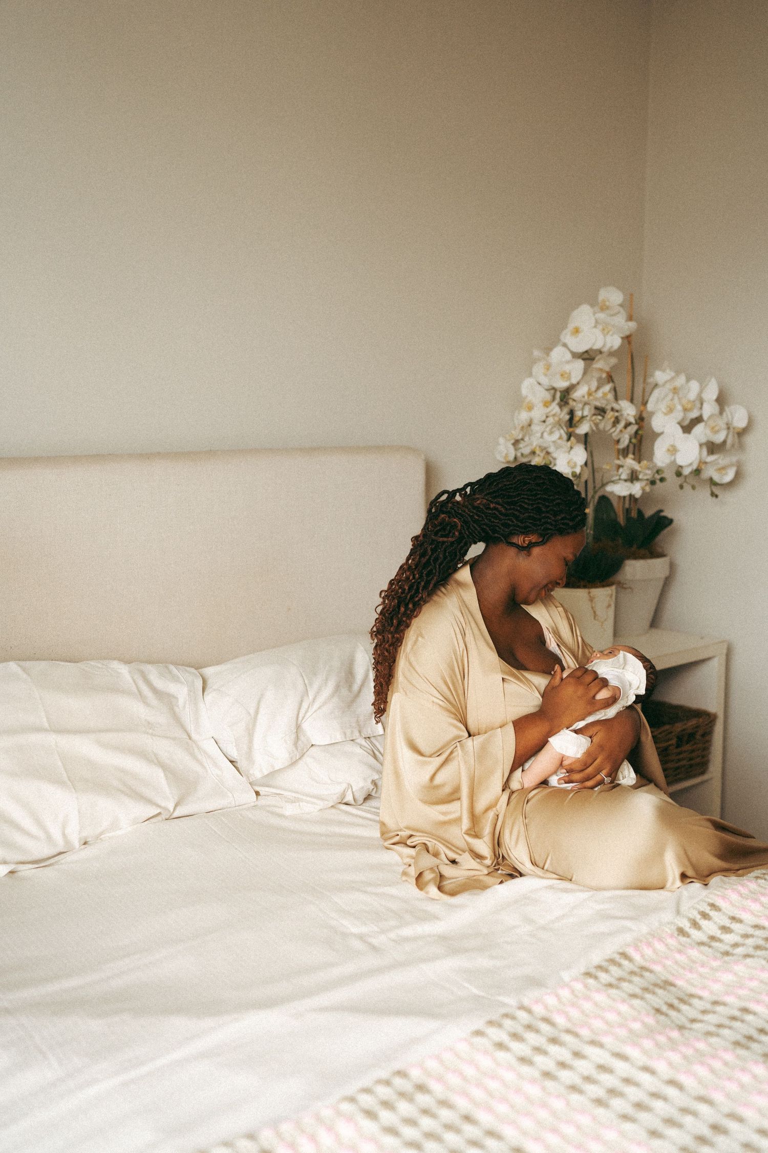 Lifestyle photos of woman reclining on white bedding in natural light.