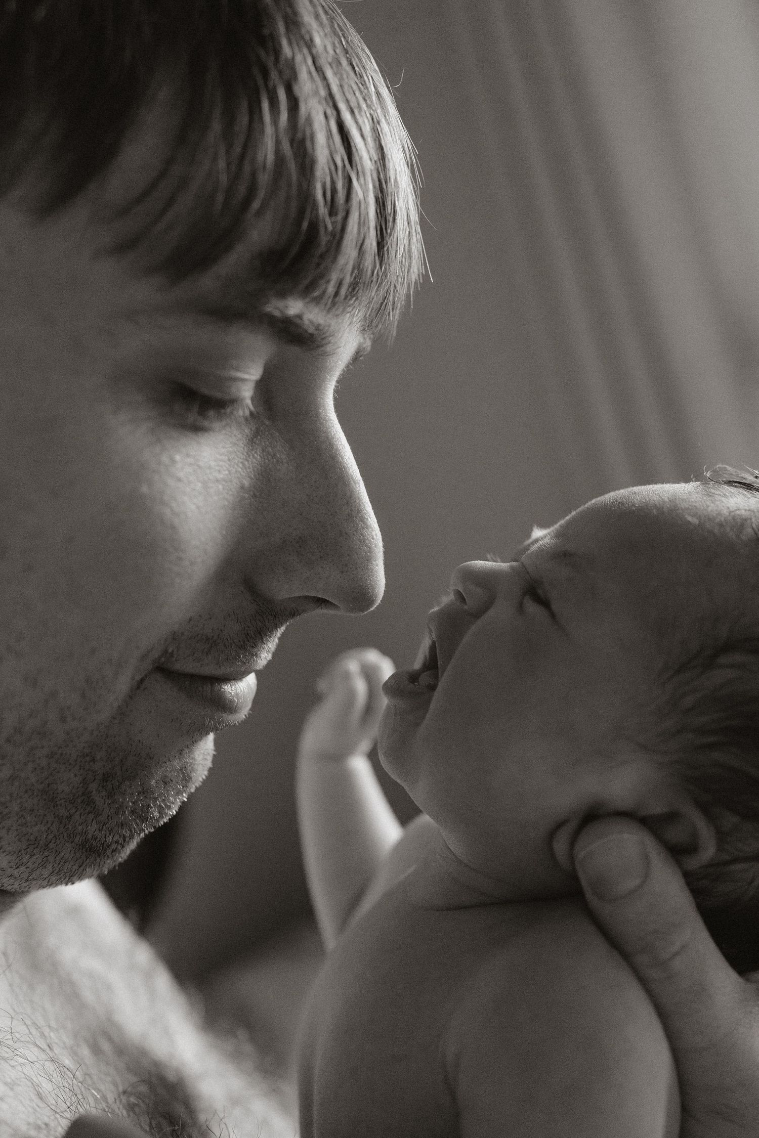 Close-up black and white photo showing tender moments of affection in a sequence.