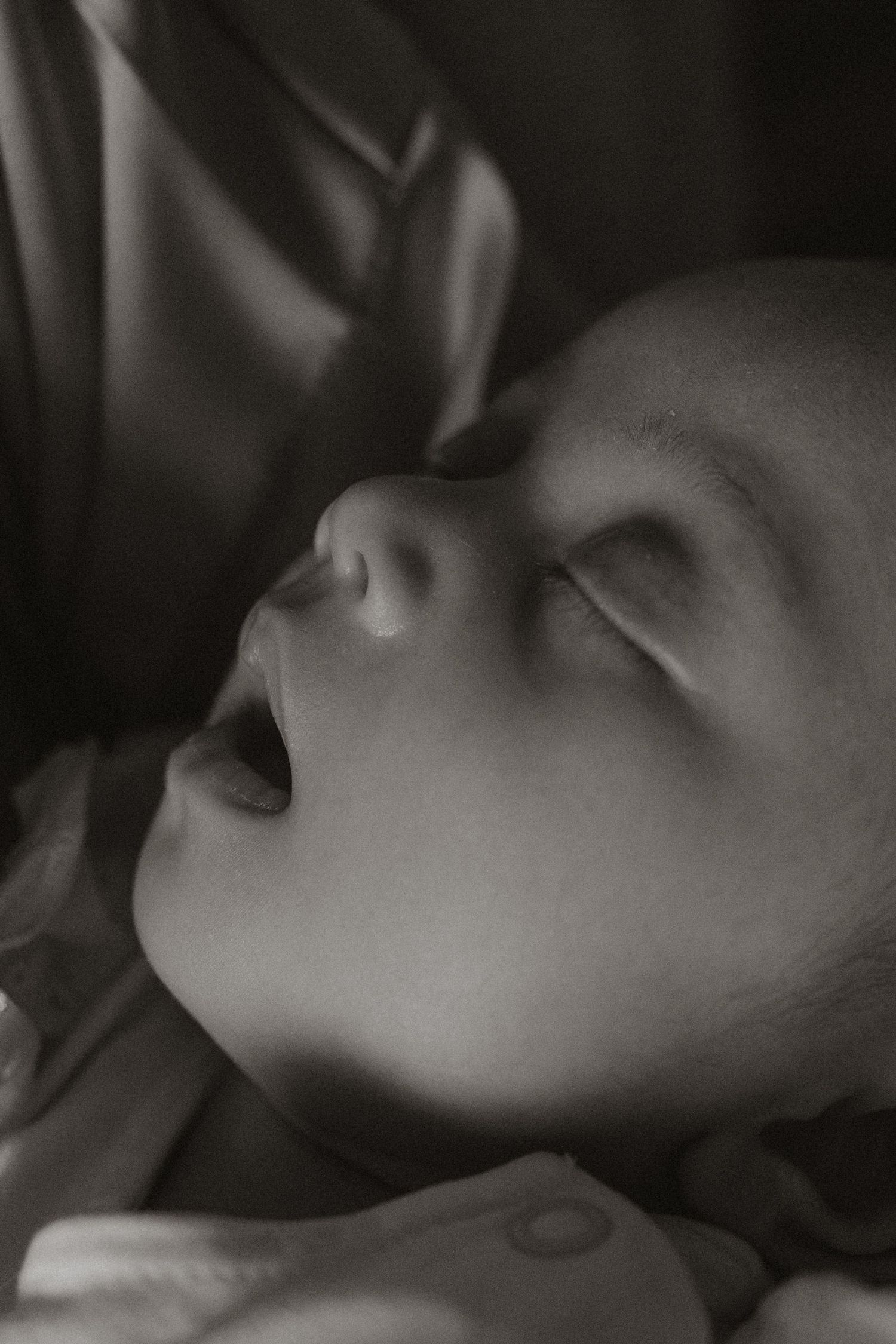 Artistic black and white close-up portrait showing peaceful expression.