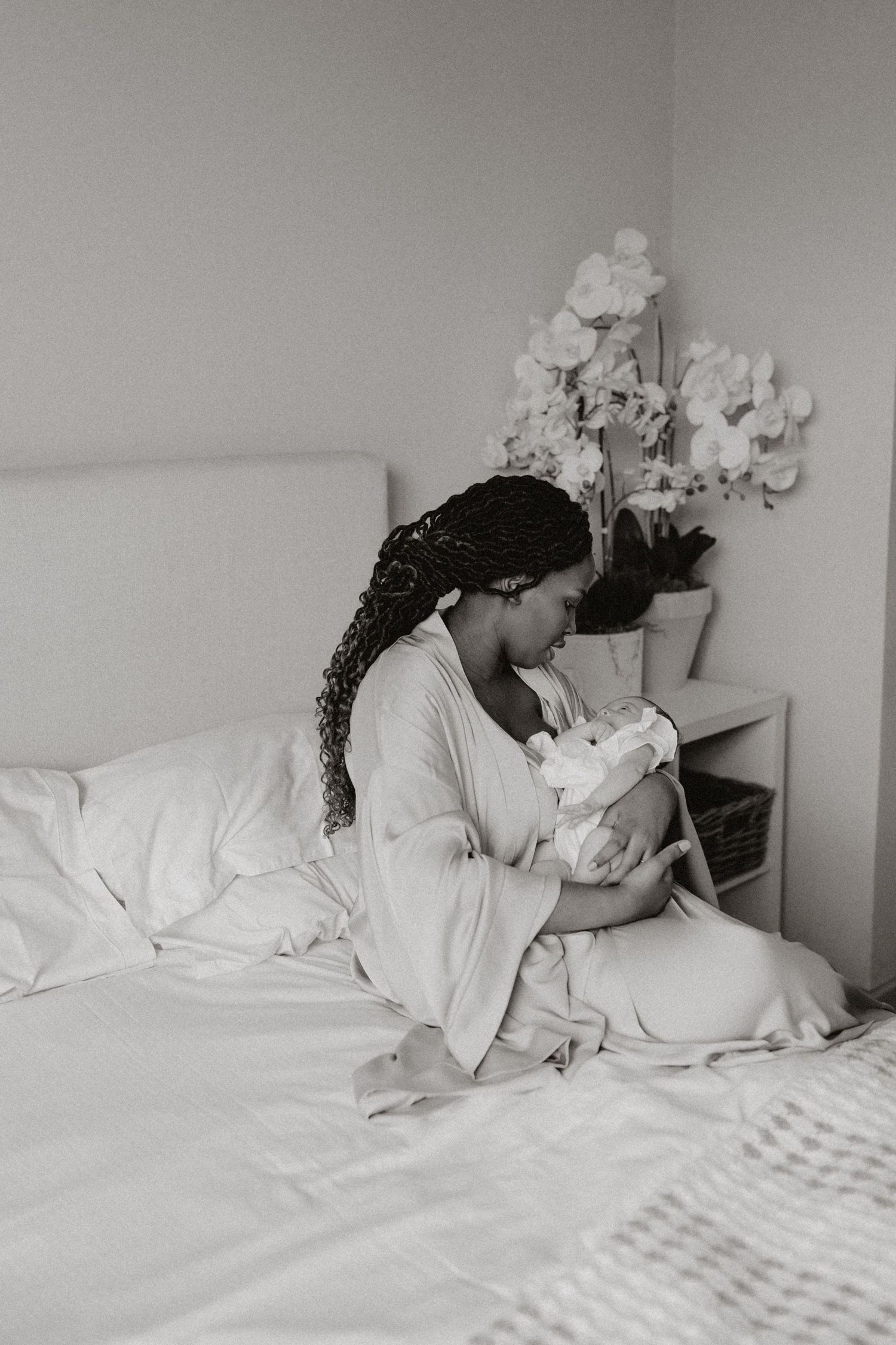 Peaceful bedroom scene showing quiet moments of bonding in white linens.