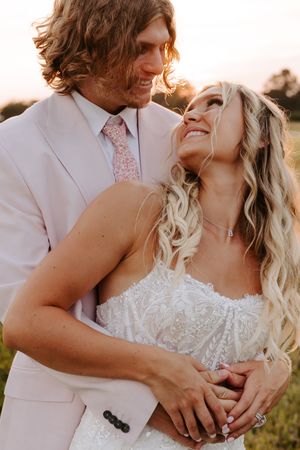 Intimate sunset portrait of wedding couple in formal white attire sharing romantic moment. Lafayette, Indiana wedding.