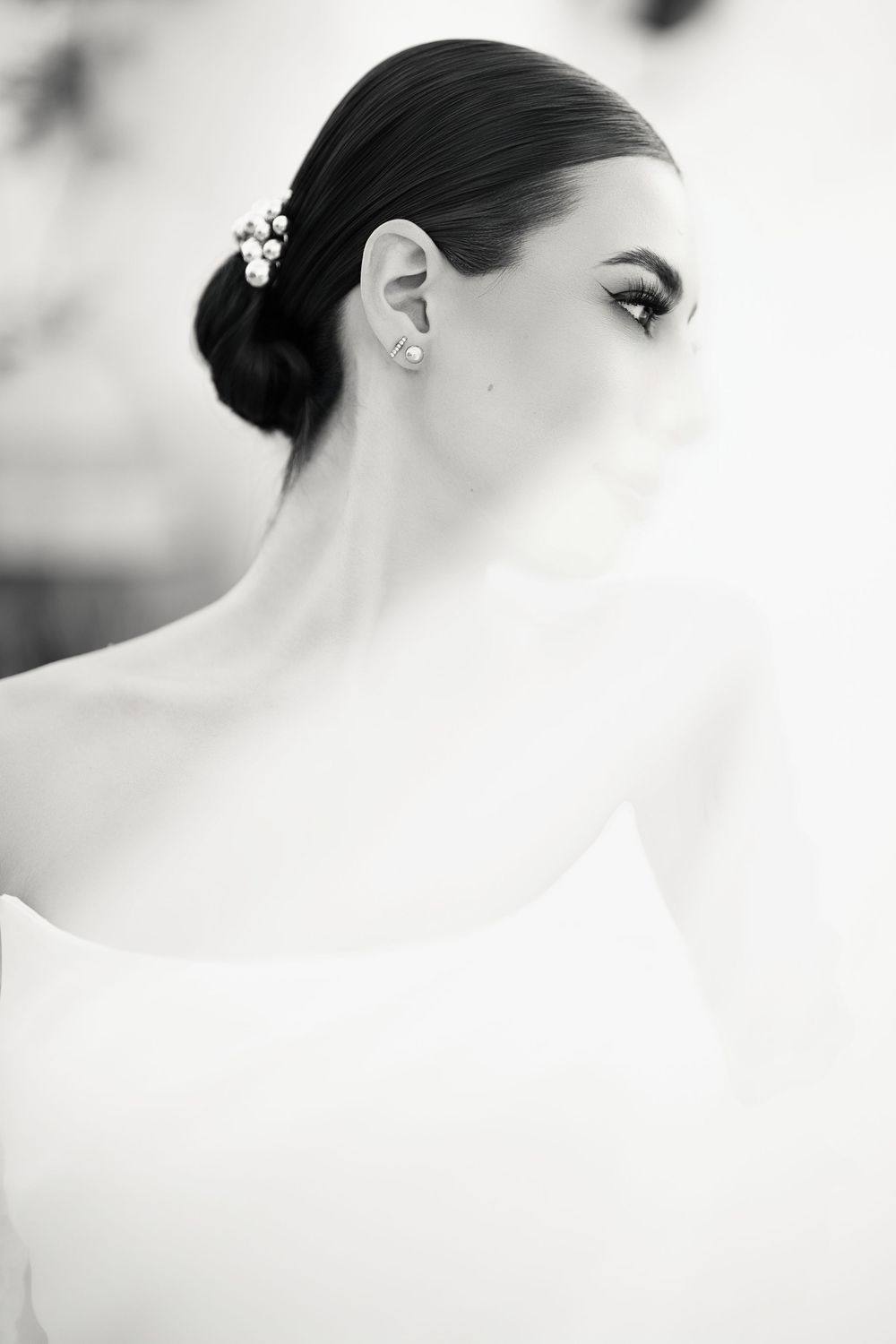 Minimalist black and white bridal portrait with elegant hair styling and veil details.