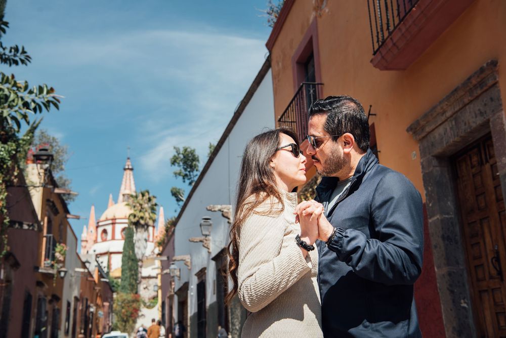 A romantic couple shares intimate moments while exploring colorful streets in San Miguel de Allende, Mexico.