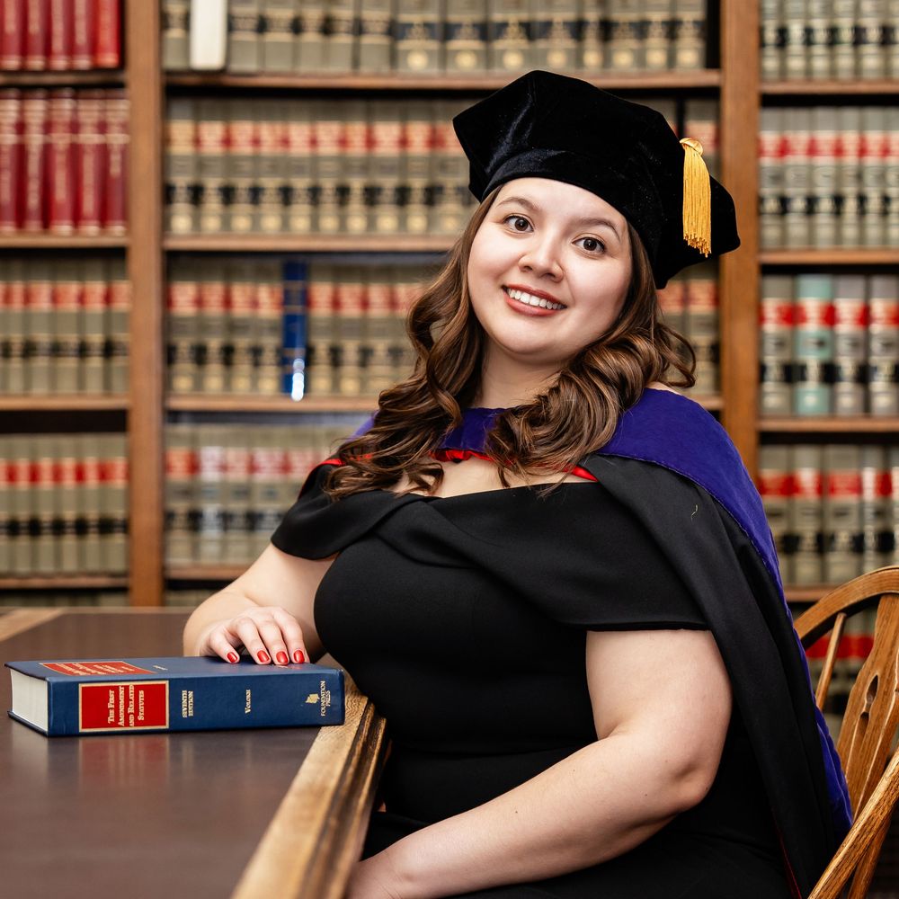 A graduate wearing her cap and stole in a library taken by Milwaukee senior photographer Rachel Dickman.