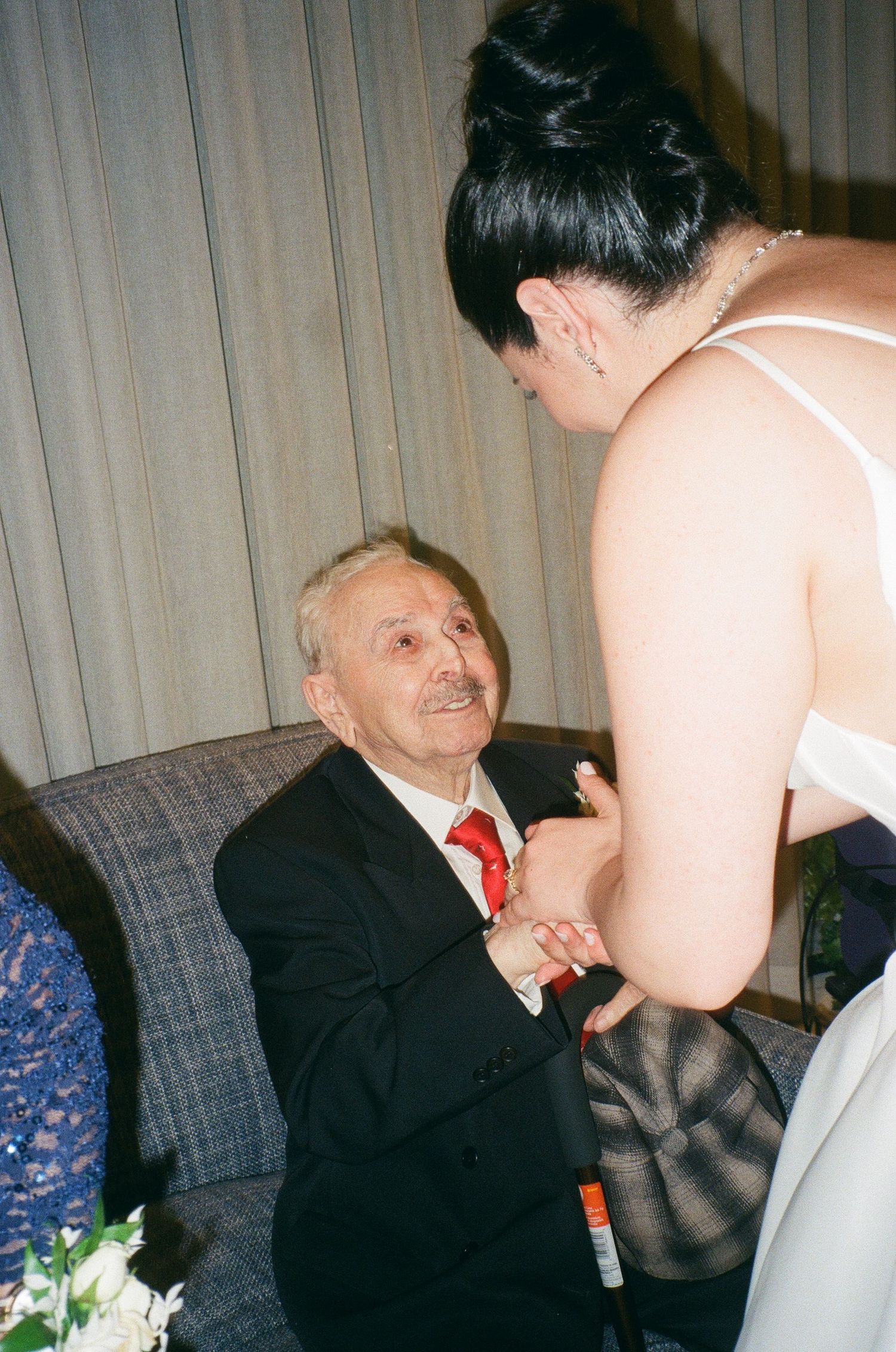 A series of candid photos showing people conversing on a couch with curtains in the background.