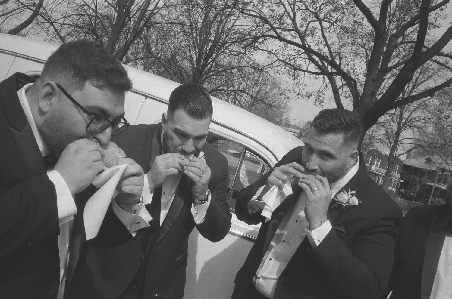 A sequence of black and white photos showing people laughing and reacting emotionally outdoors.