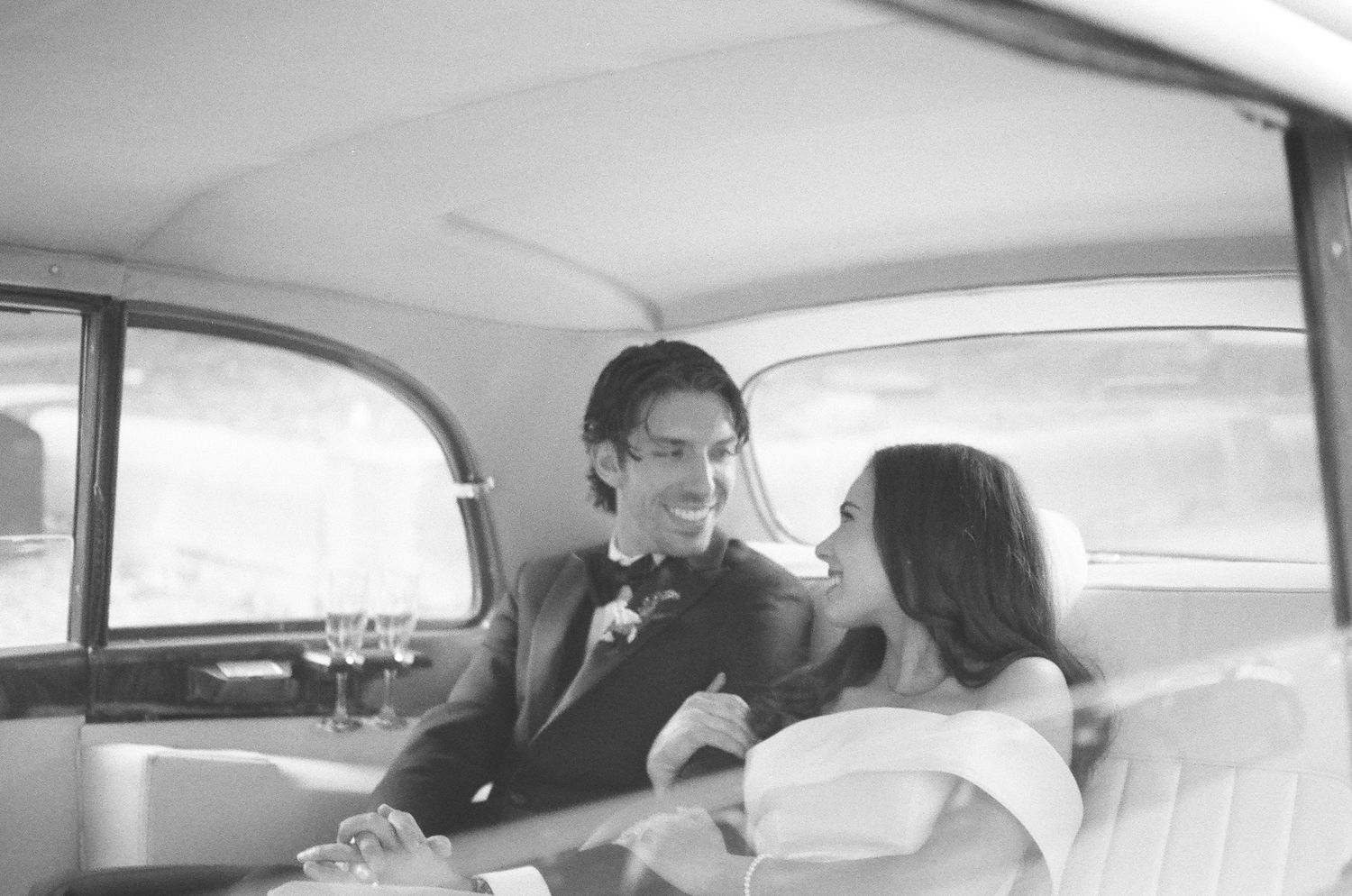 A sequence of black and white photographs showing people inside a car interior with natural lighting through windows.