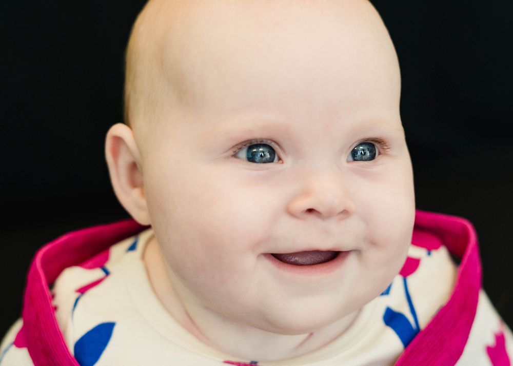 Smiling child in casual preschool setting — personality-filled photo