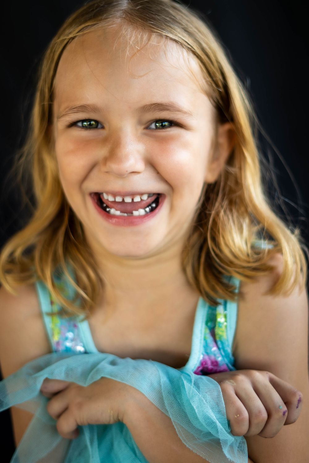 Daycare student with joyful expression photographed in natural light by Portraits by Aliza.