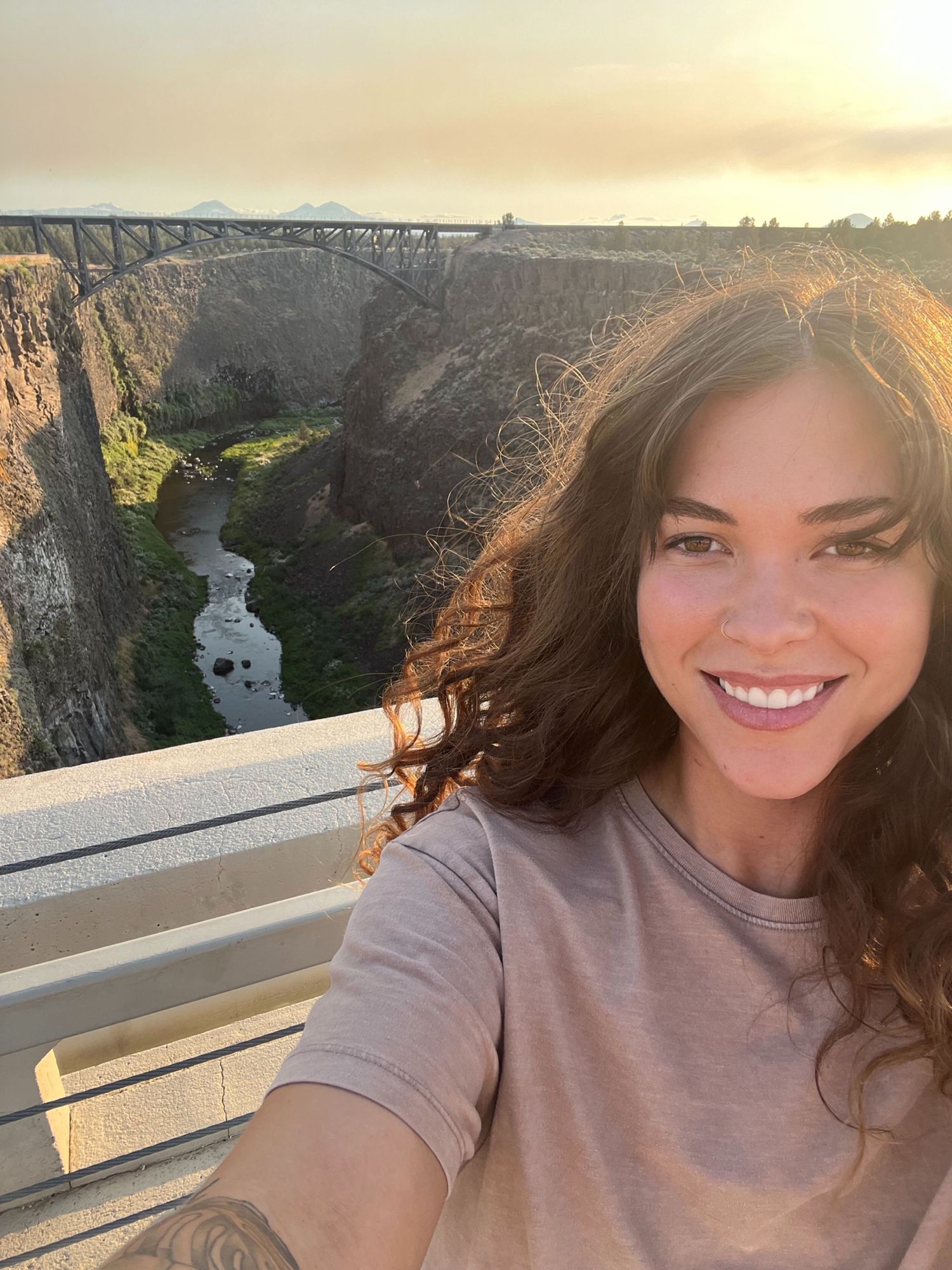 Selfie series taken on a bridge during golden hour with scenic canyon views. Oregon elopement photographer.