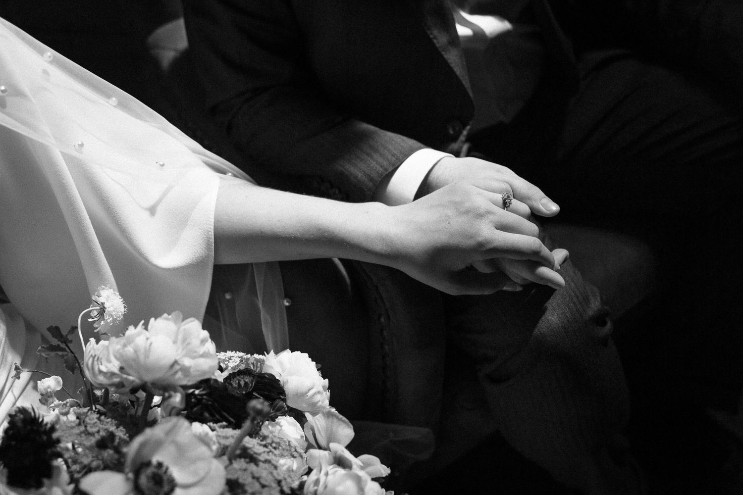 close up shot of bride and groom holding hands