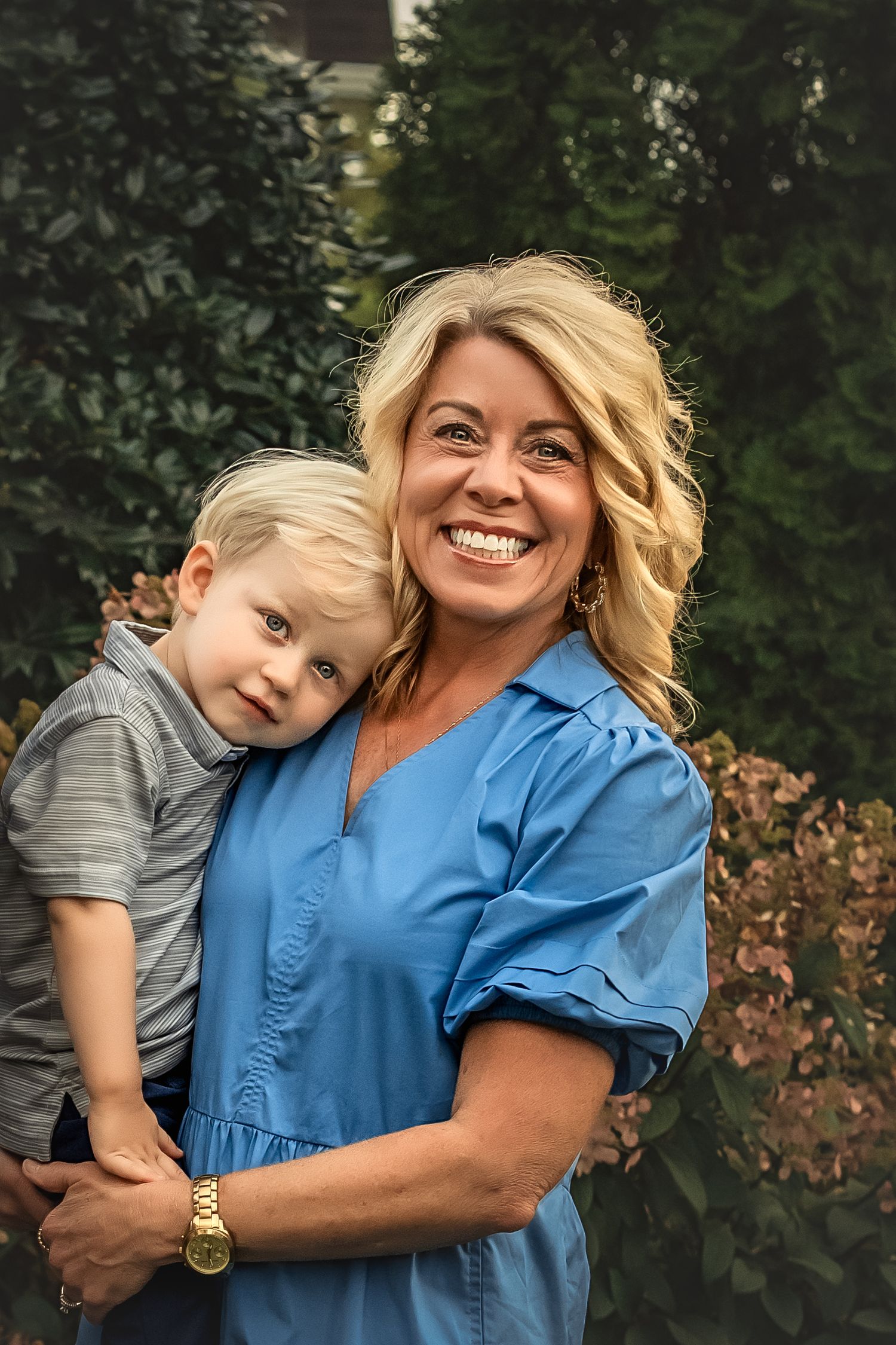 A heartwarming outdoor photoshoot showing joyful moments between two people in a natural garden setting.