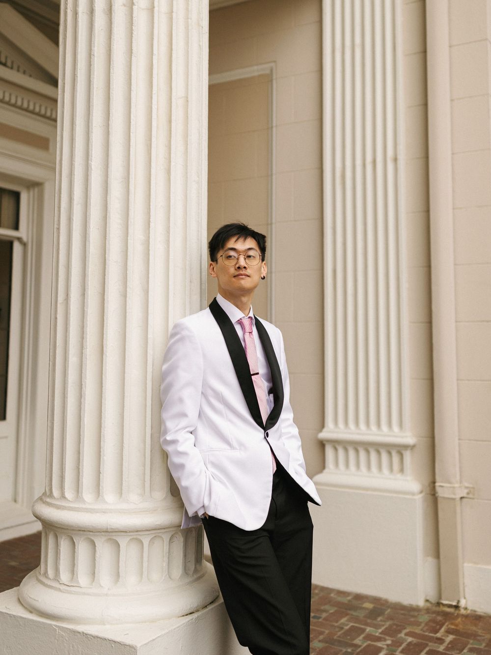 Three connected photos show someone in a white tuxedo jacket and black vest posing against classical columns at different angles.
