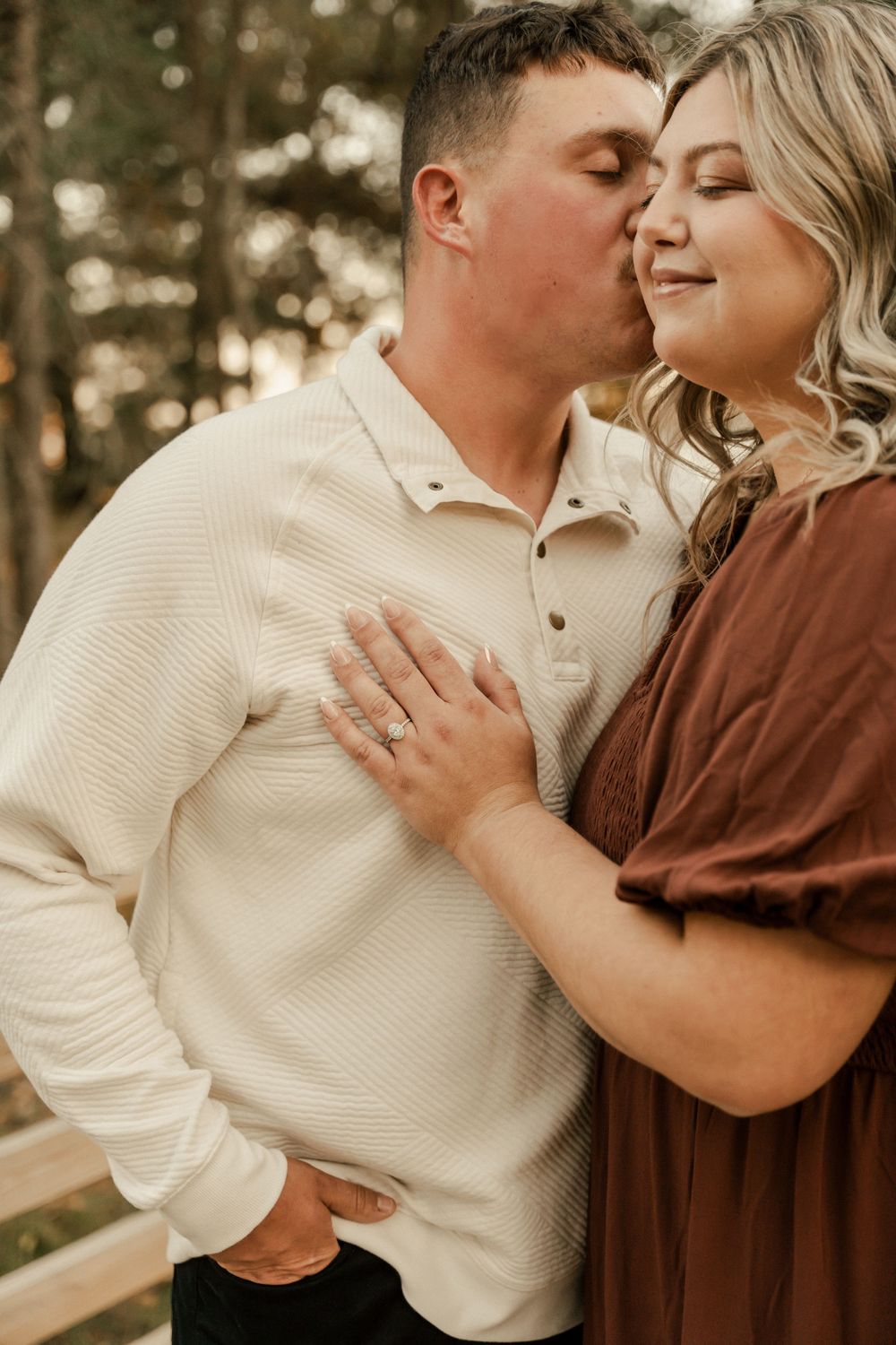 A romantic couple in cream and brown outfits share tender moments in a series of intimate outdoor photos.
