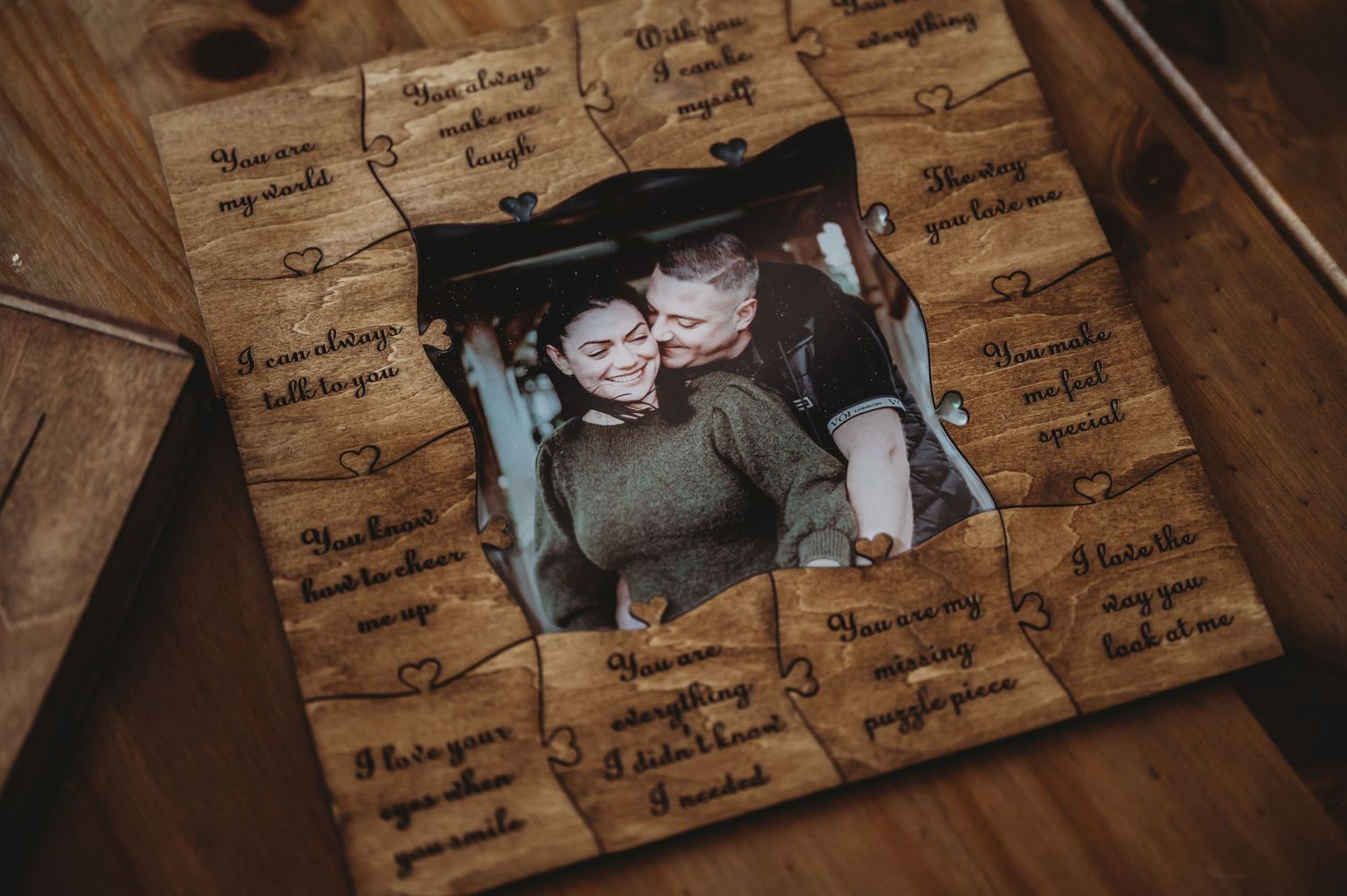 A wooden frame with handwritten messages surrounds a photograph, creating a sentimental keepsake display.