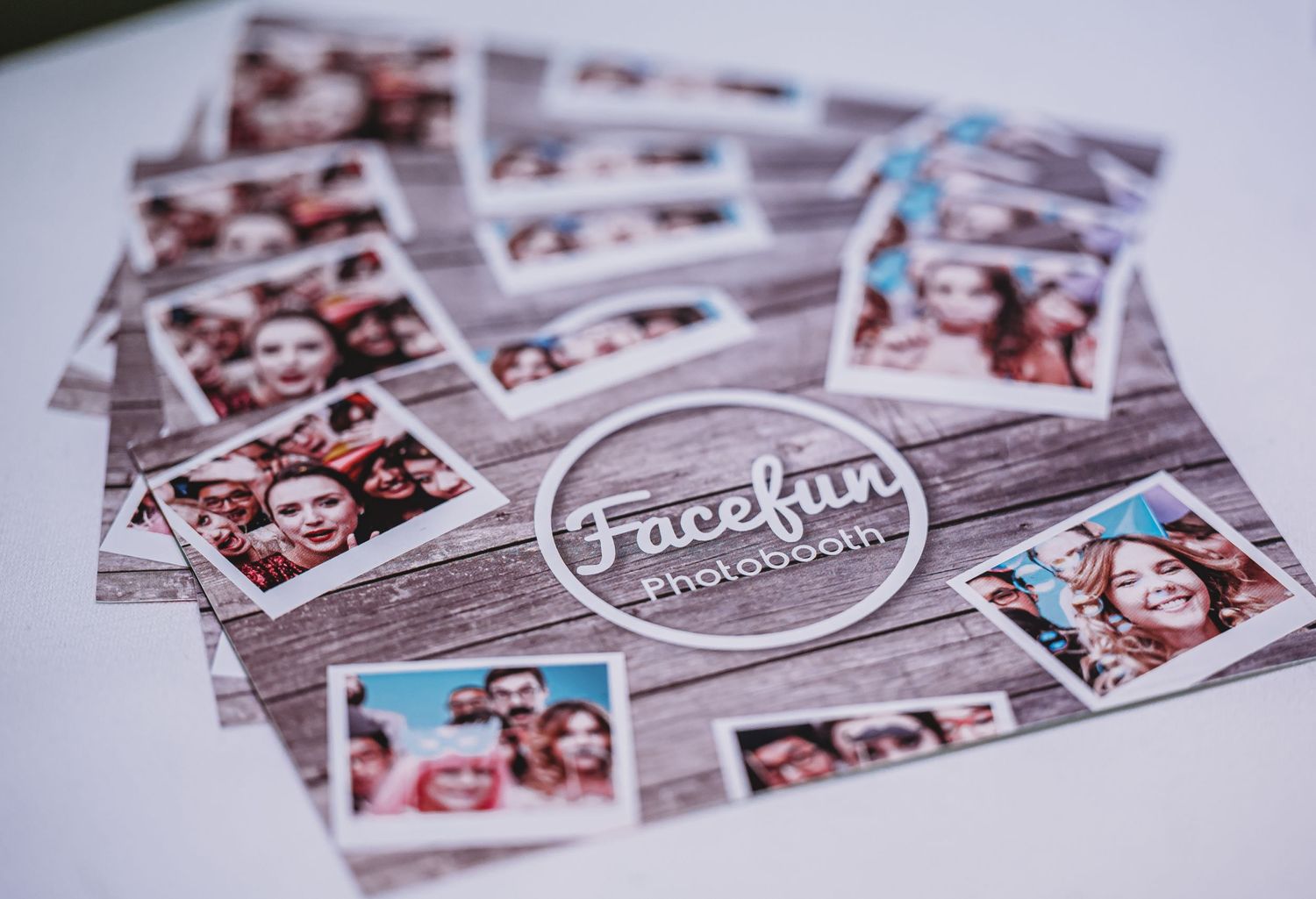 A collection of photo booth pictures arranged on a wooden surface with a circular 'Facefun' logo overlay.