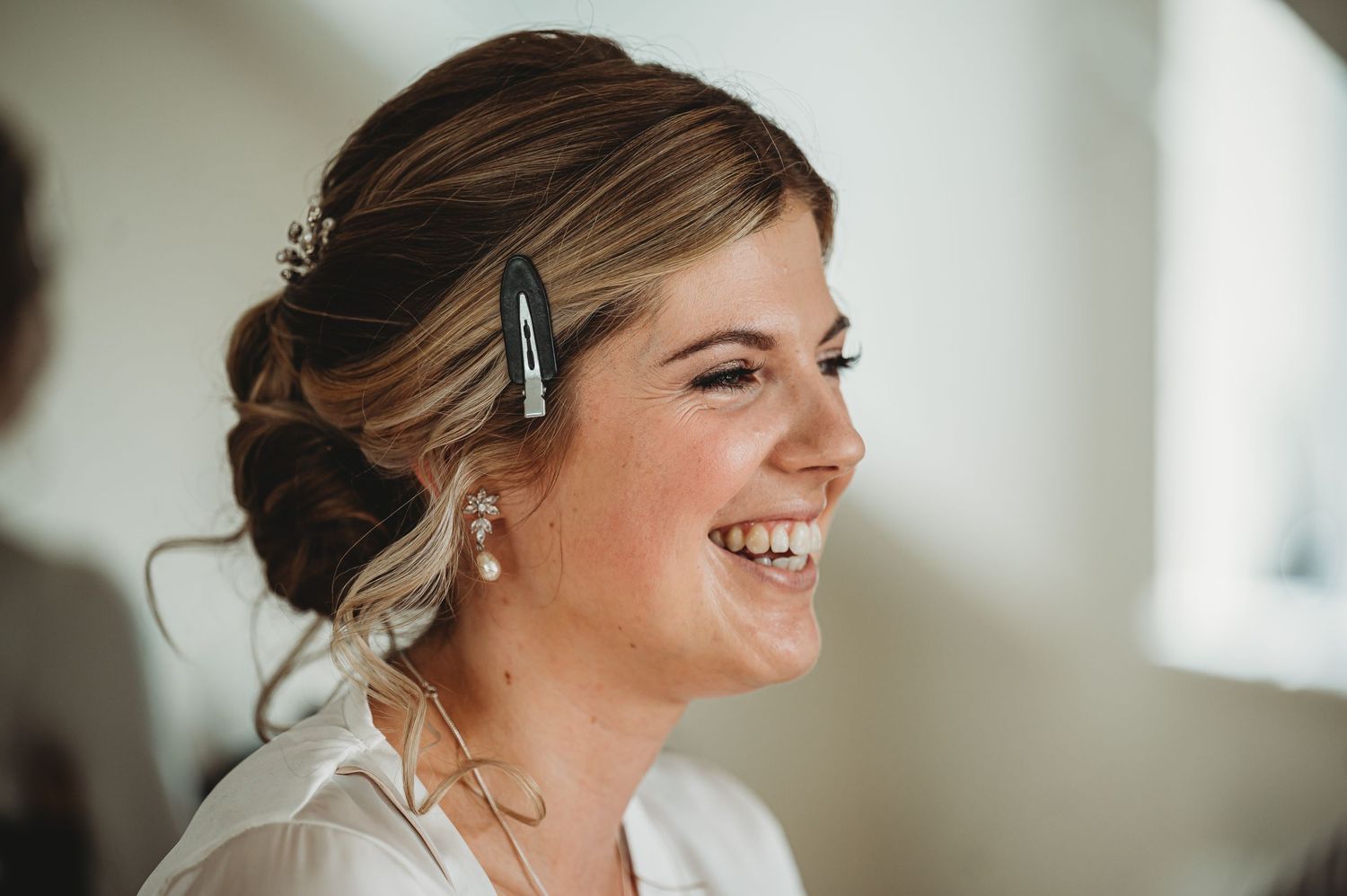 Getting ready shot of bridal preparations with elegant hair styling.