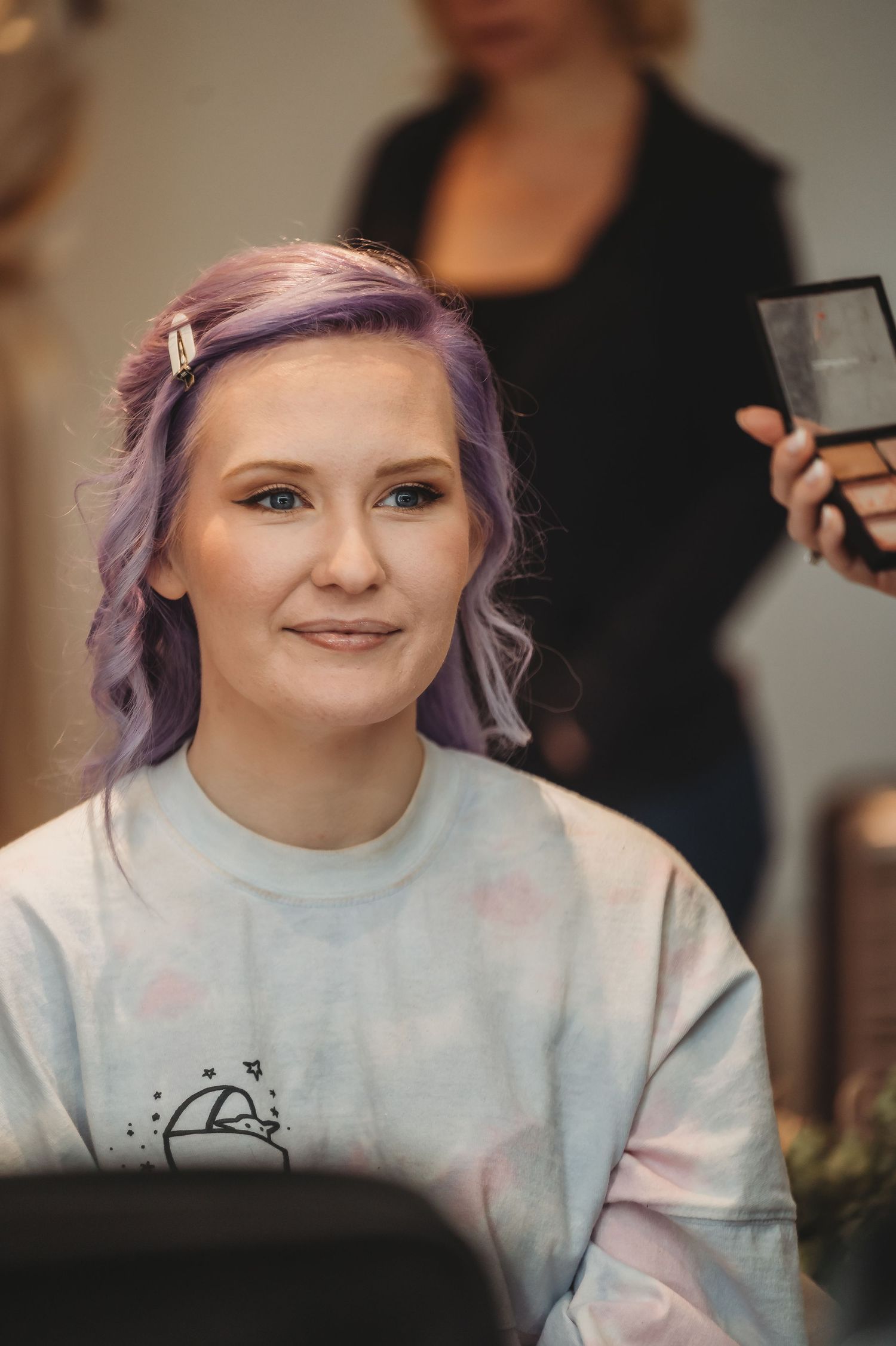 A person with lilac-colored hair getting ready for a special event.