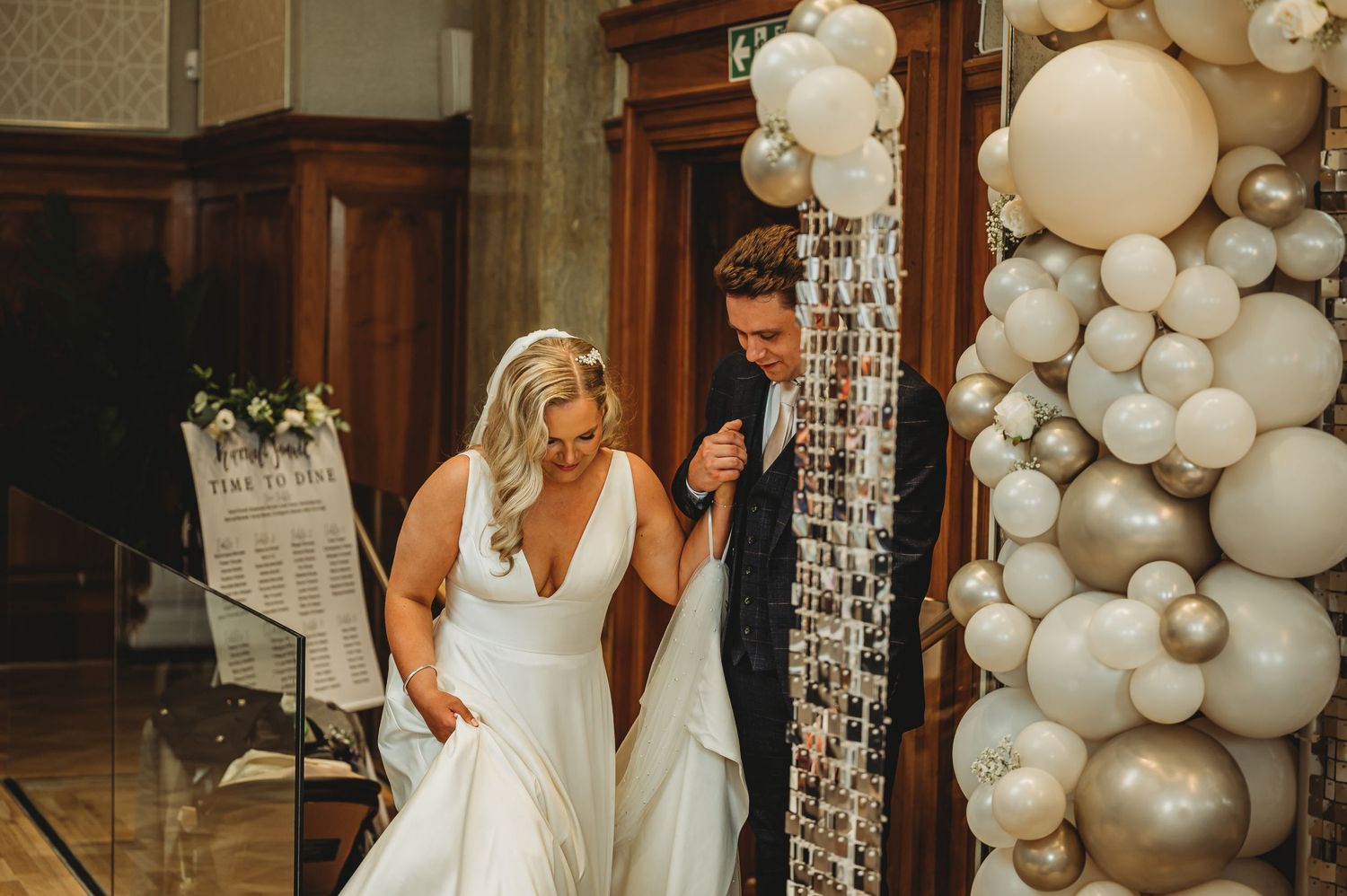 Elegant venue decorated with white and silver balloon installations.