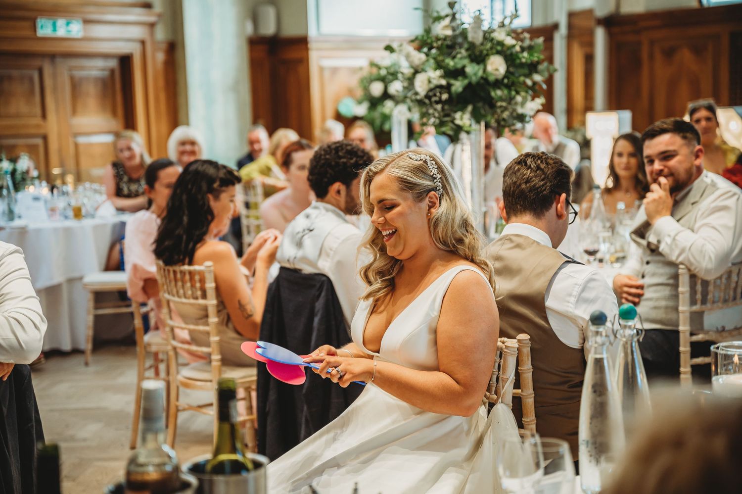 Wedding reception venue with guests seated at decorated tables.