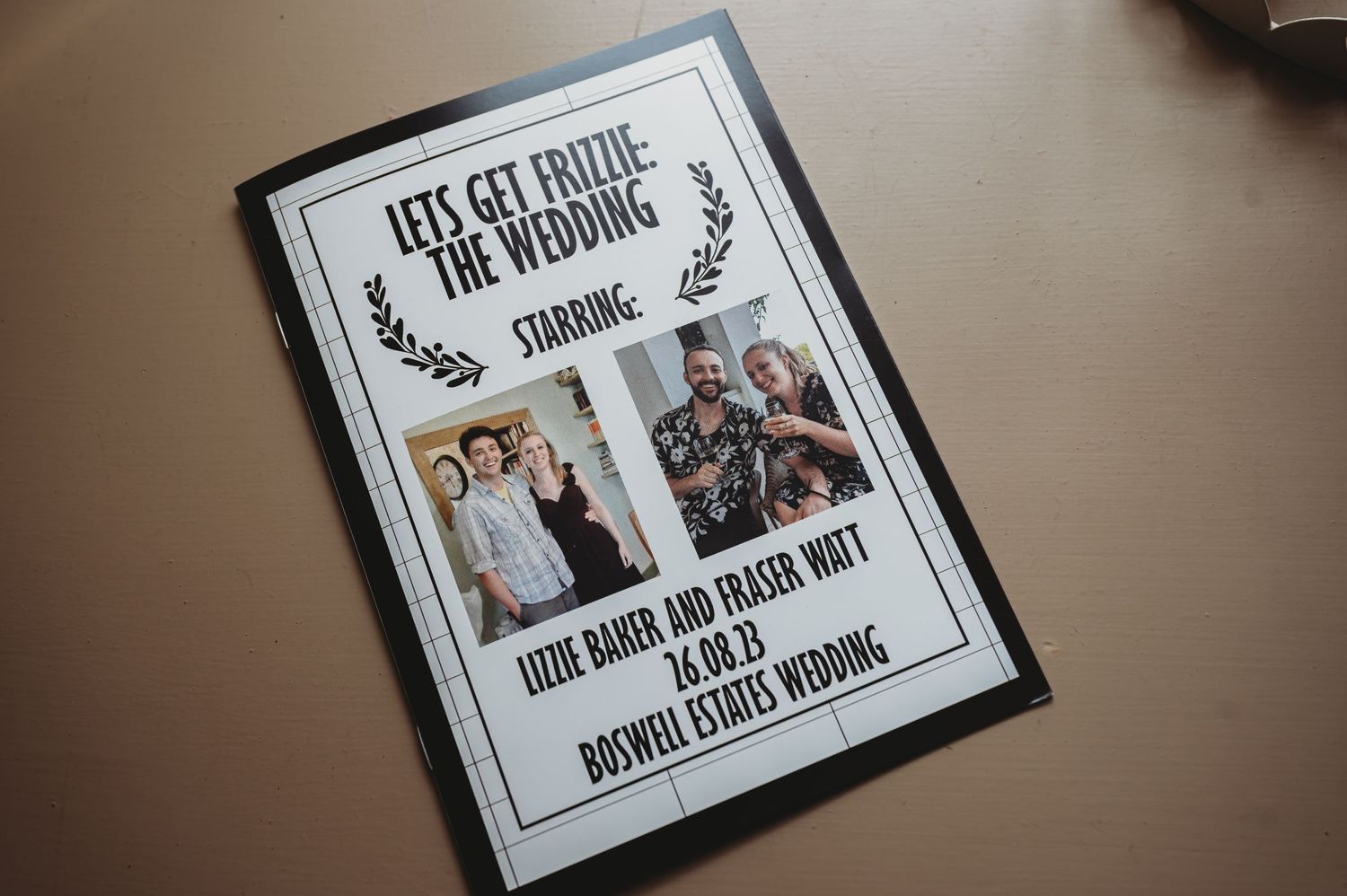 A wedding photo album cover with 'Let's Get Digital' text and two framed photographs lies on a tan surface.