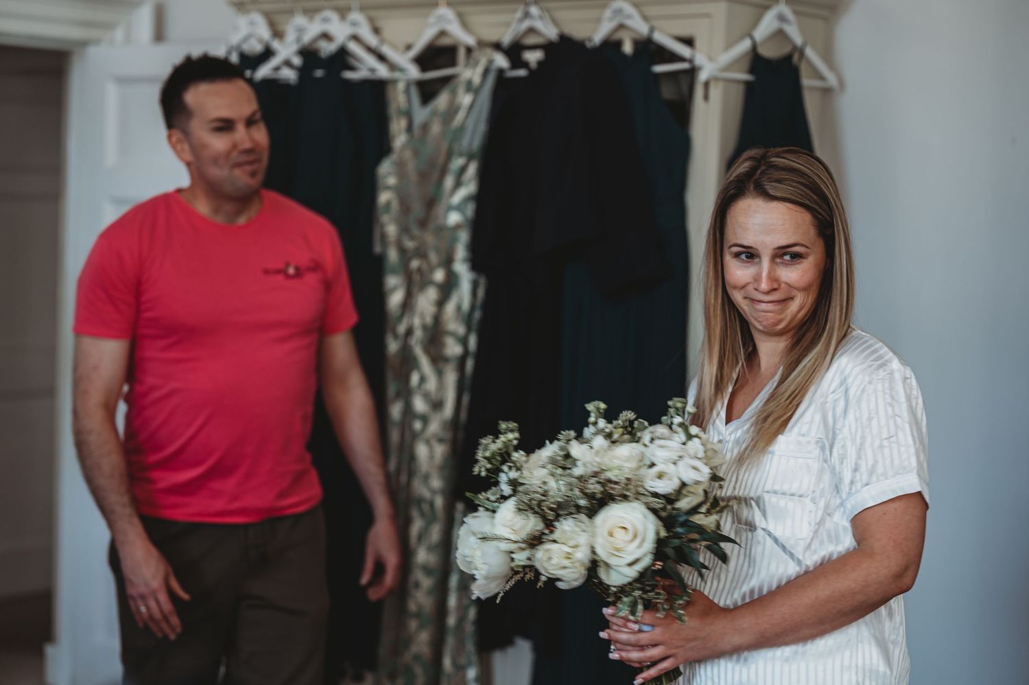 Wedding preparation scene with formal attire and white floral bouquet.