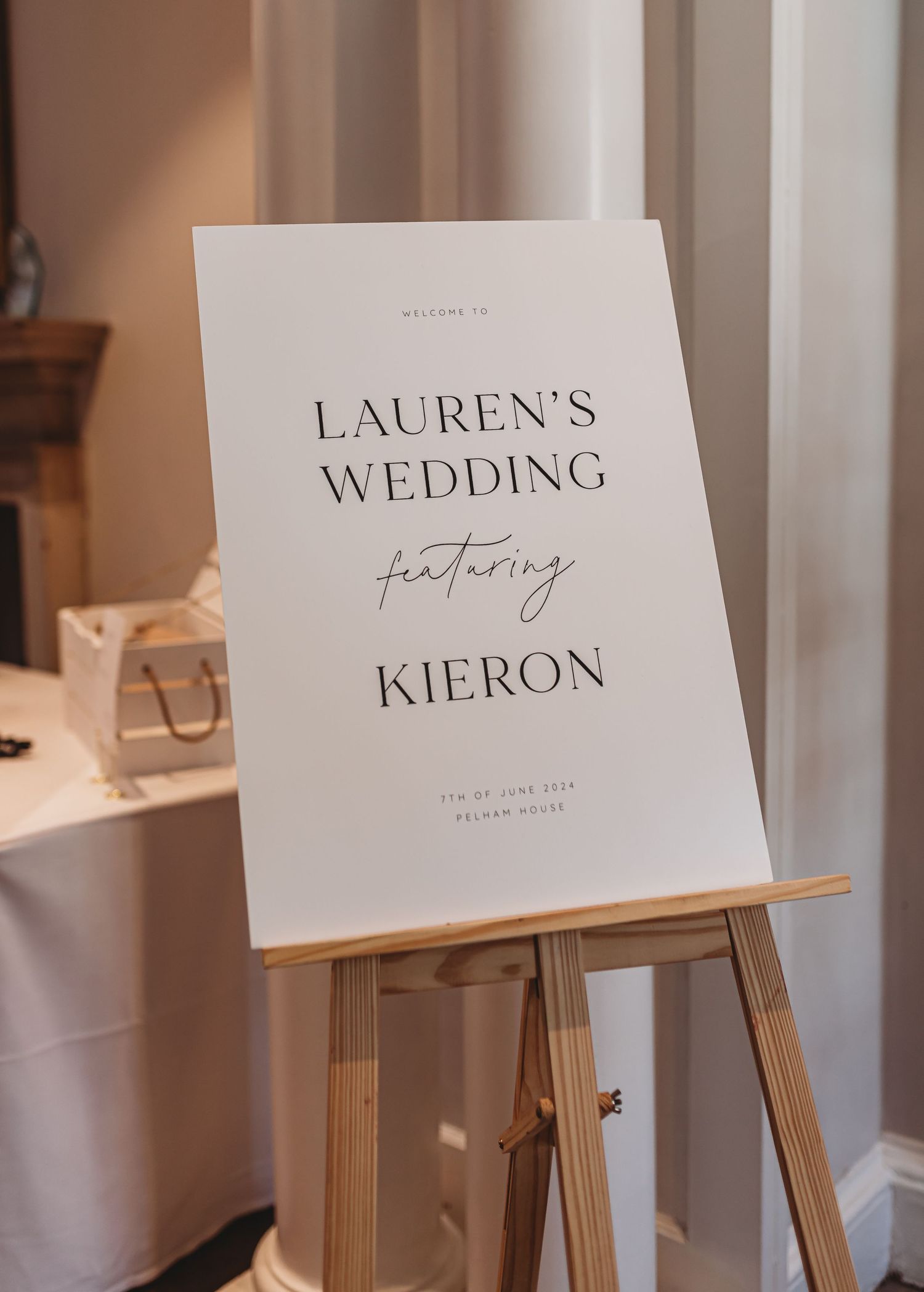 Elegant wedding welcome sign for Lauren and Kieron displayed on wooden easel.