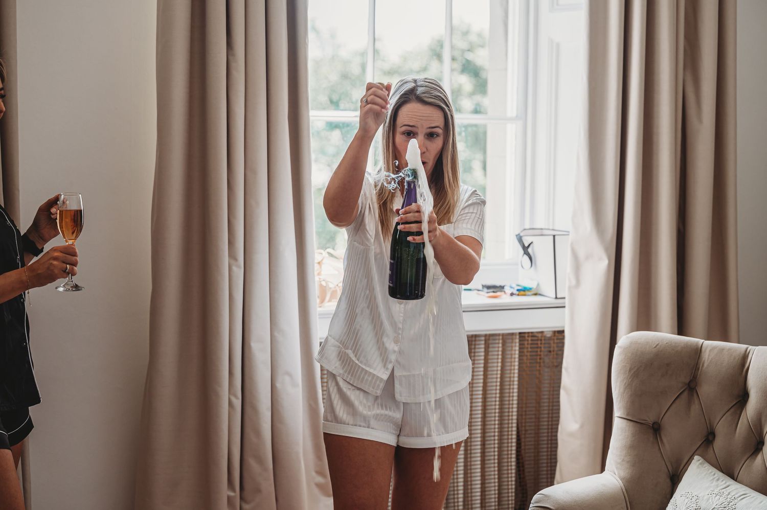 Festive celebration scene with champagne in elegant room with window.