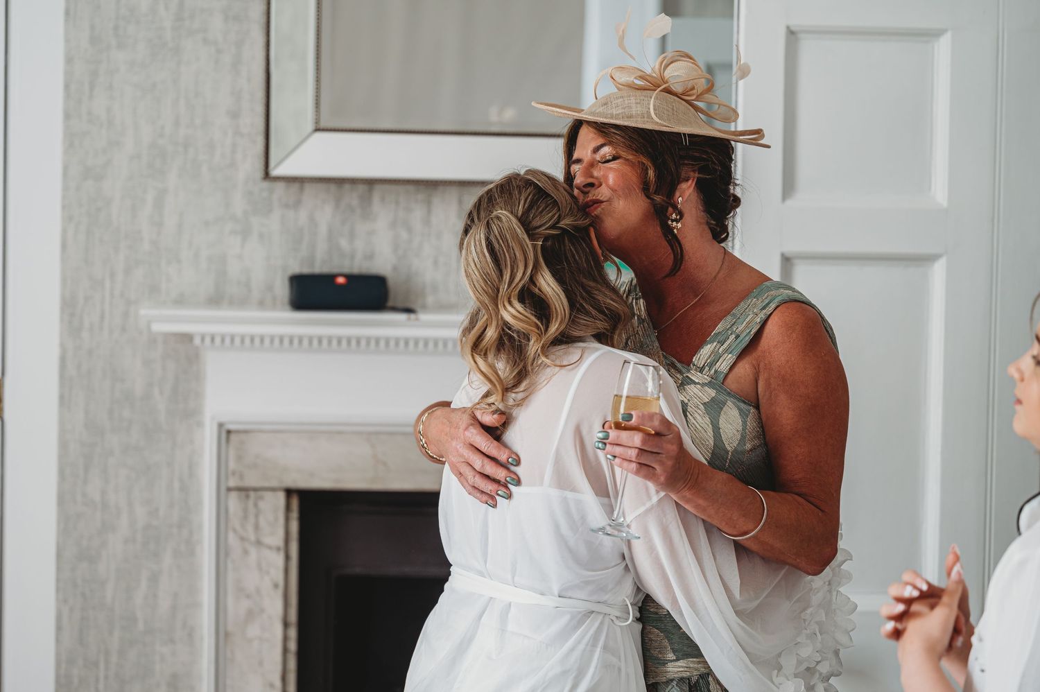 A couple sharing an intimate dance moment near a fireplace during what appears to be a celebration.