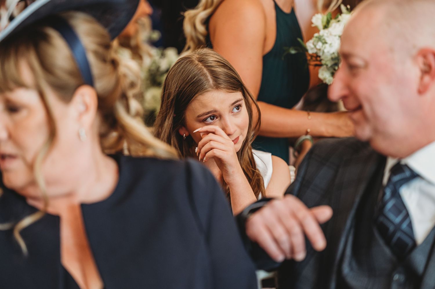 Candid emotional moment captured during wedding reception.