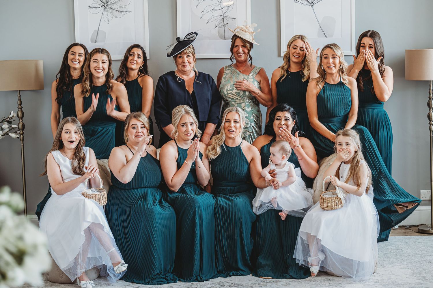 Wedding party poses together wearing teal bridesmaid dresses making funny faces.
