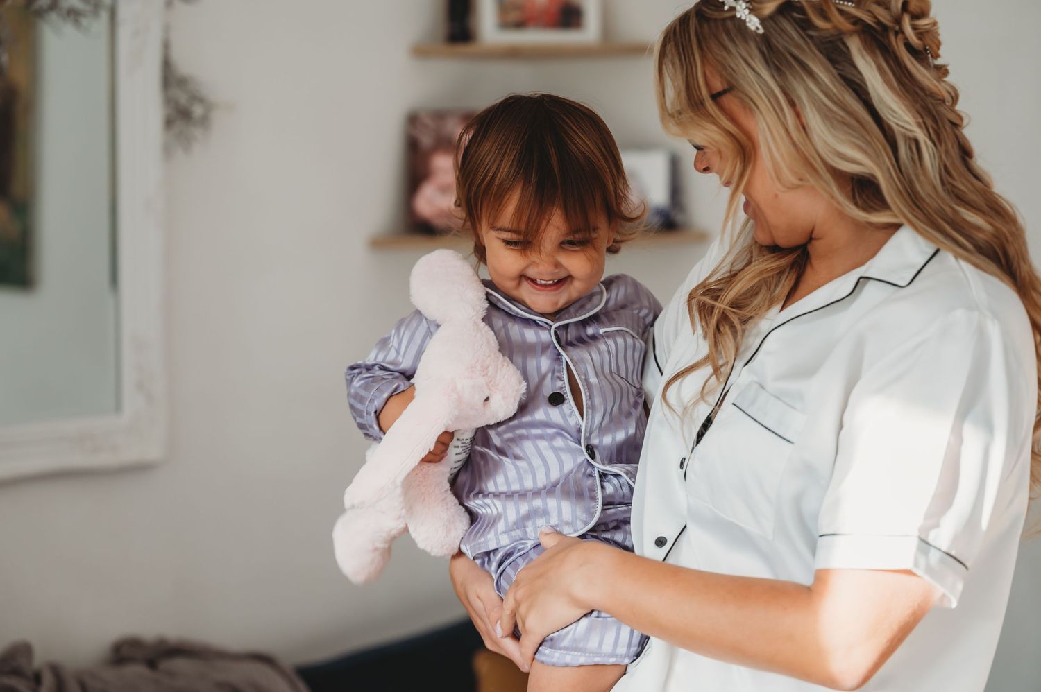 A tender moment captured indoors with gentle natural lighting and soft tones.