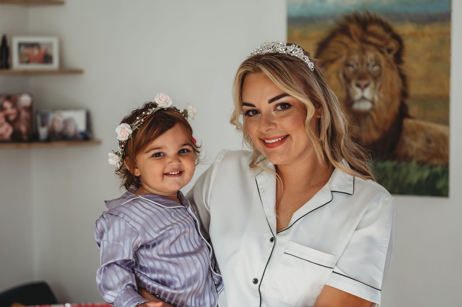 A family photo at home with a vibrant lion painting on the wall.