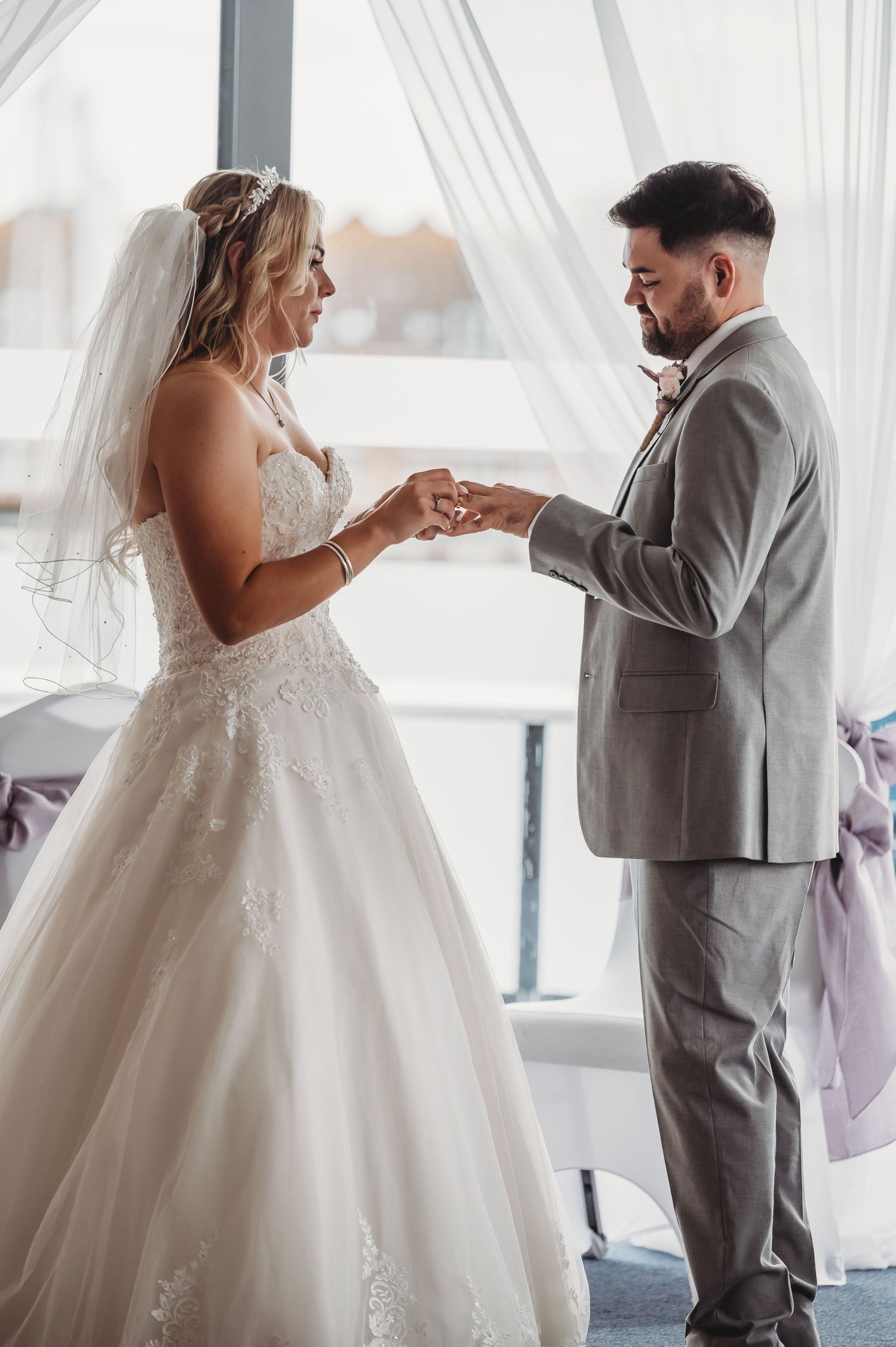 A tender moment during a wedding ceremony as rings are exchanged.