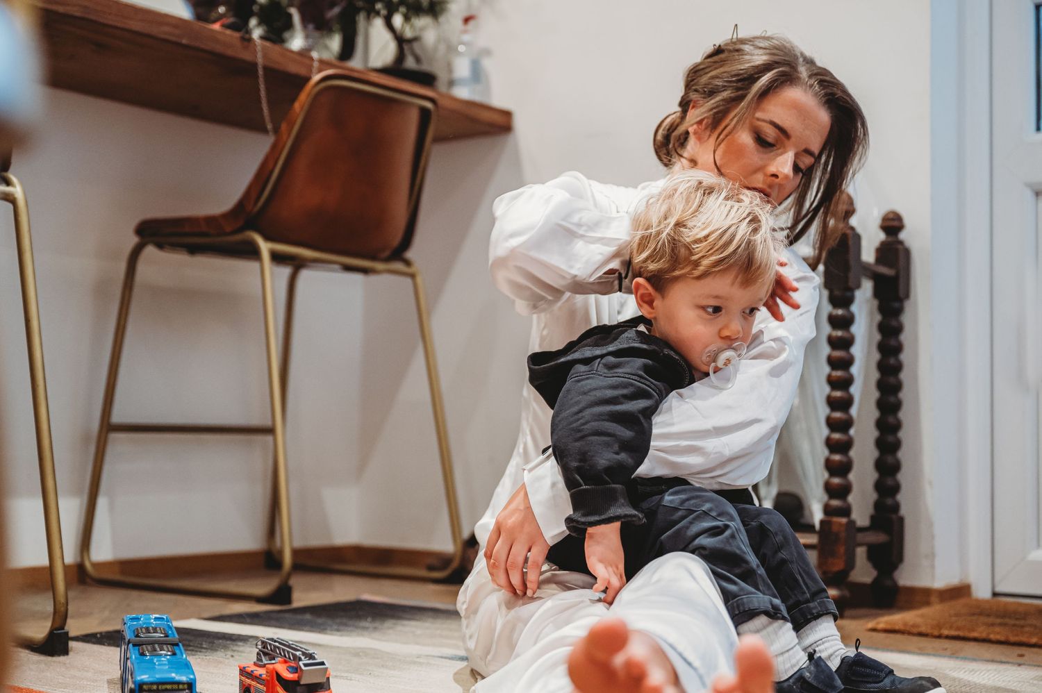A tender moment between parent and child while playing with toys at home.