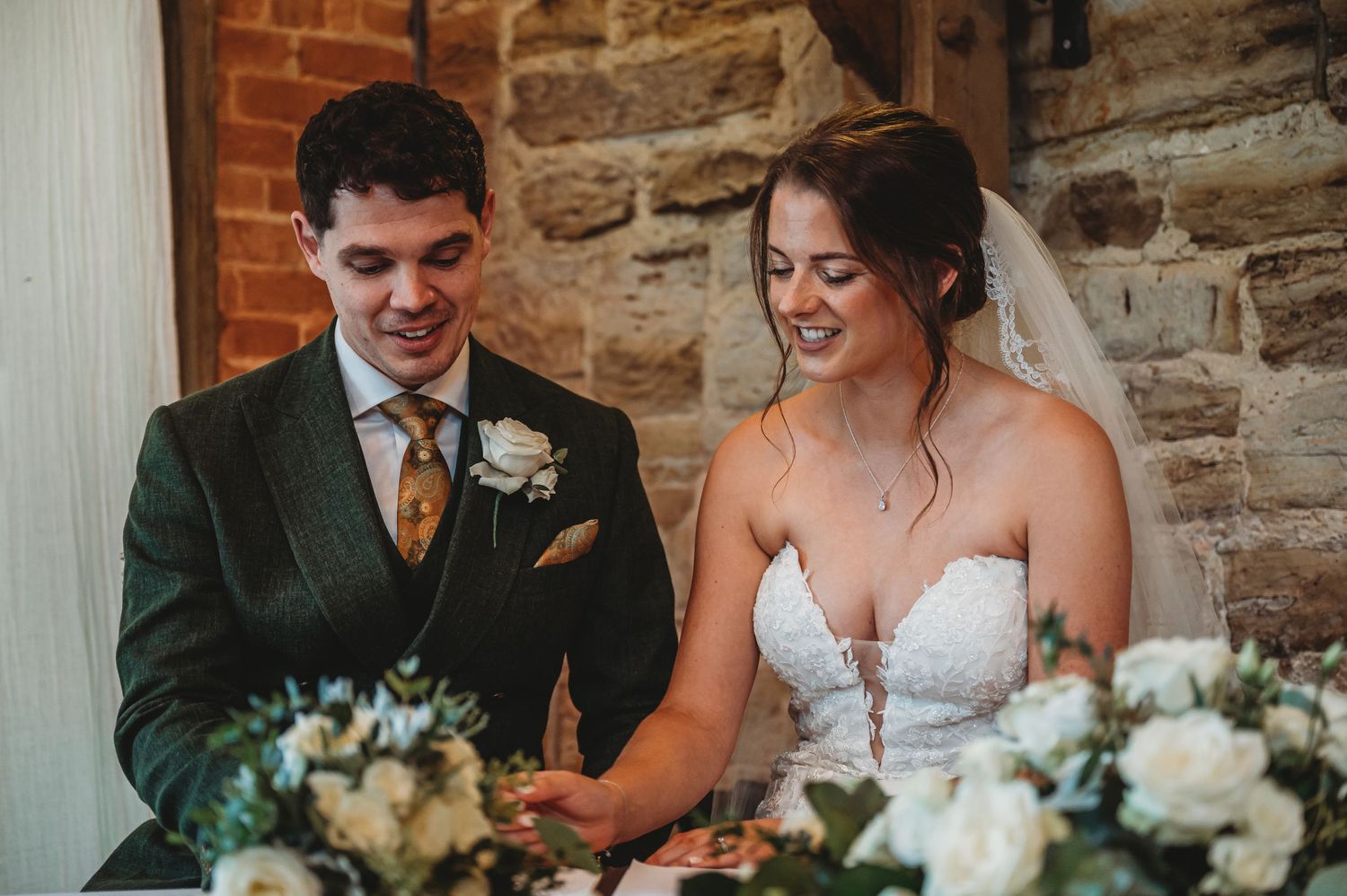 Wedding celebration at rustic venue with exposed brick and stone walls.