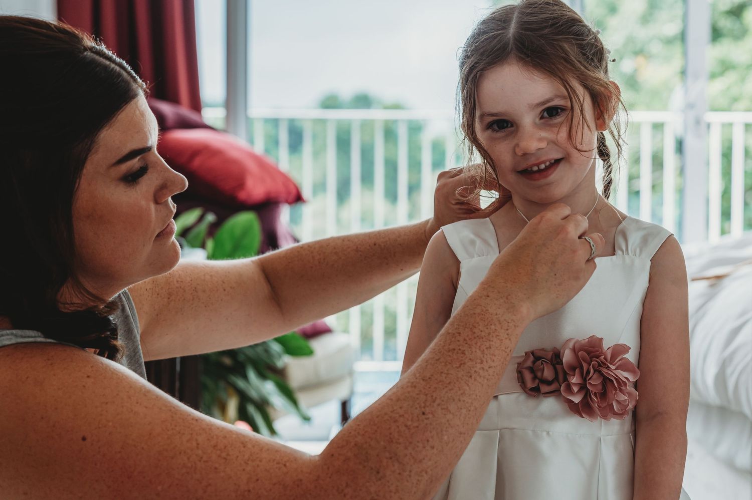 Wedding day preparations as final touches are made to a bride's elegant attire.