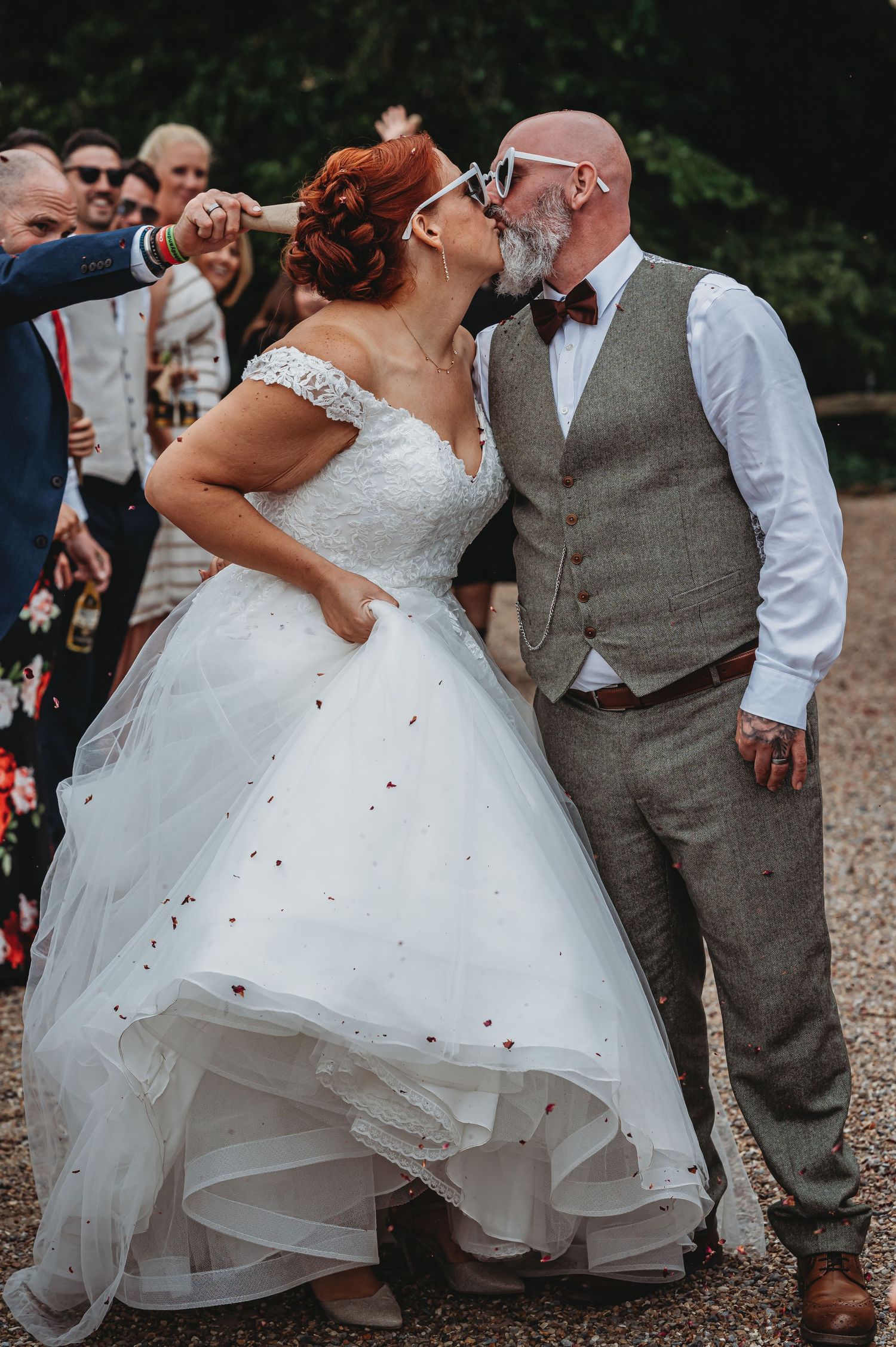 A joyful wedding moment captured outdoors showing the love between a couple in formal attire during their celebration.